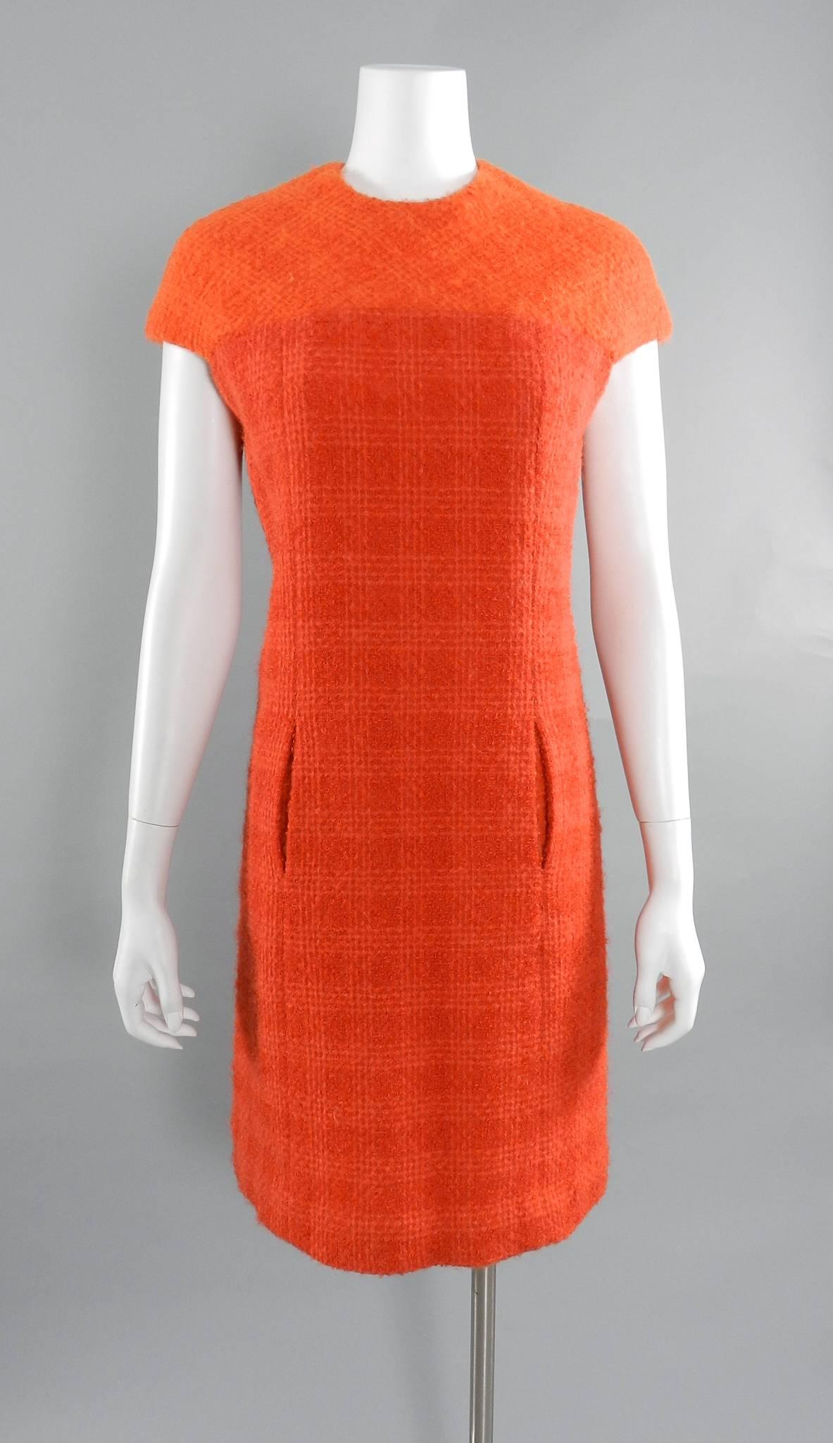 Vintage early 1960's Norman Hartnell orange boucle wool dress suit. Dress is two-tone orange boucle wool with centre zipper and buttons at back neck. Matching jacket / coat has a sheared beaver fur collar. Approximate size USA 10/12 Large. Dress