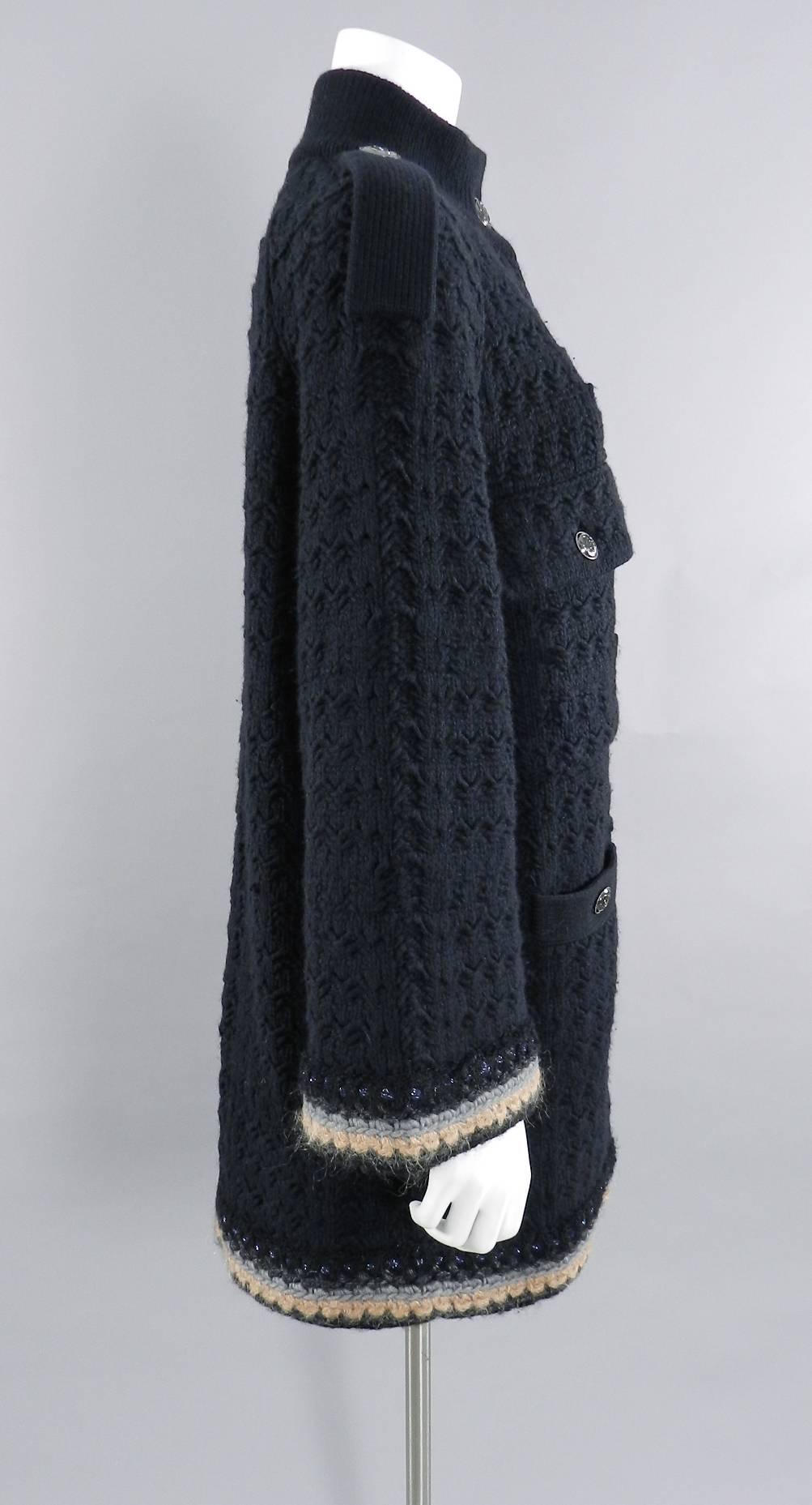 Chanel 13B black cashmere chunky knit oversized sweater coat. Original retail price tag $4125+.  Dark grey metal buttons, wide sleeves, front pockets, peach and grey trim. Tagged size FR 36 (USA 4) but can fit larger as it is oversized. Garment