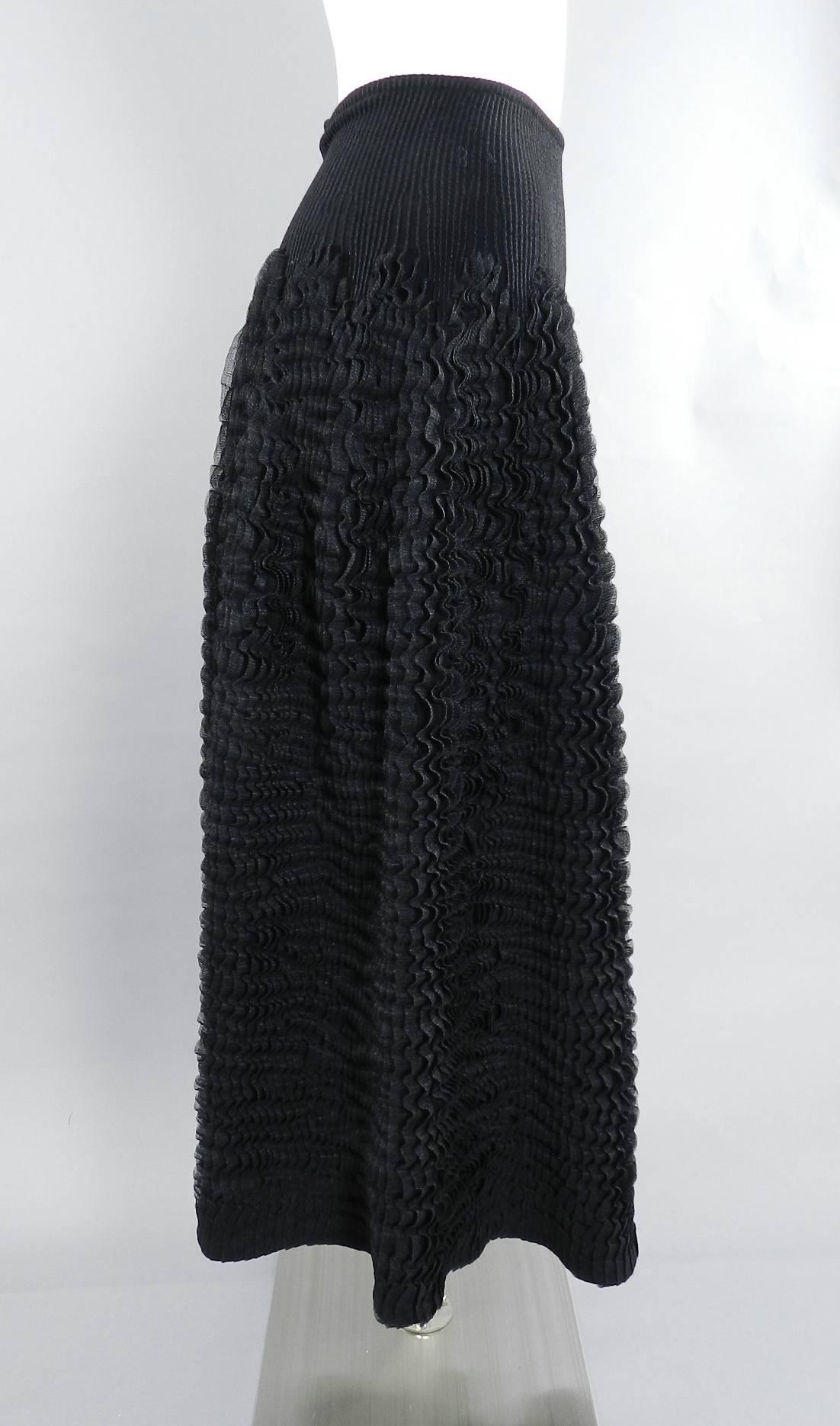 Azzedine Alaia black knit skirt.  Brand new with original retail price tag of $4975+. Stretch knit ribbed fabric with sheer knit ruffle design. Waist measures 24
