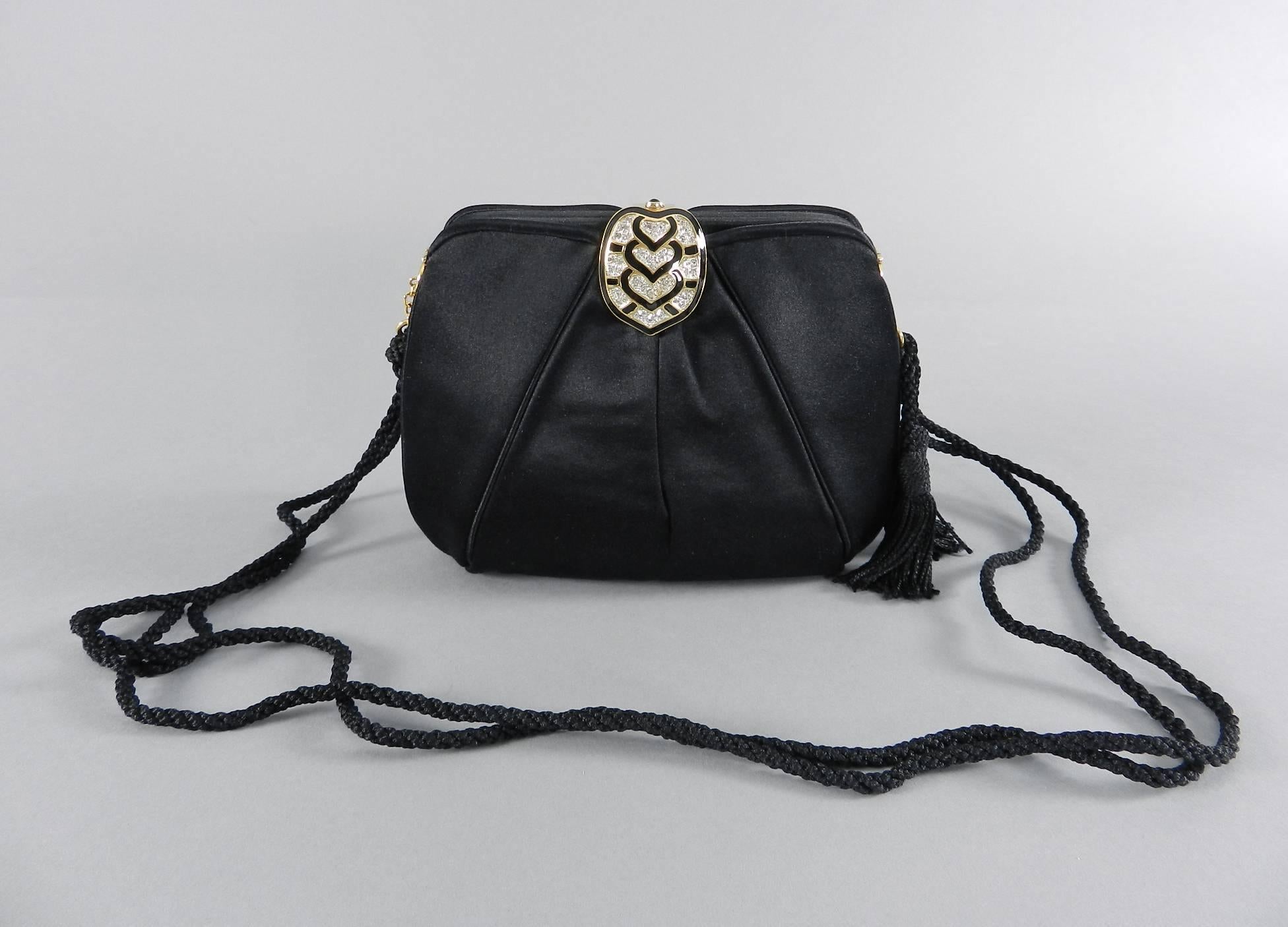Judith Leiber Black Silk Satin Evening Bag with Rhinestone Clasp.  Includes small goldtone metal comb and duster. Long rope strap with two tassels.  Art deco style black enamel, rhinestone, and goldtone metal clasp. Excellent clean condition.  Body