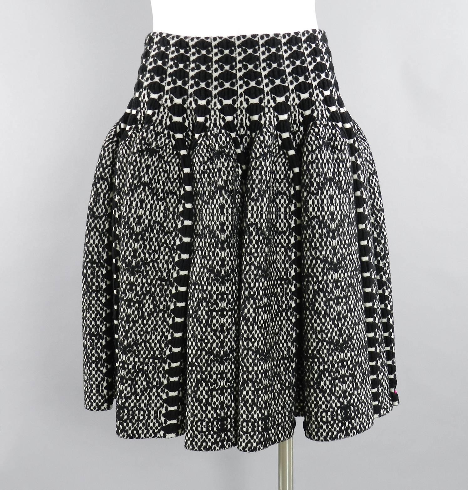 Azzedine Alaia black and white knit jersey peplum top and flare skirt.  Centre back zipper, elastic pull-on waist.  Excellent clean pre-owned condition. Worn once if at all. Top is tagged size FR 40 and skirt 38. Overall best for USA 6. (alaia runs