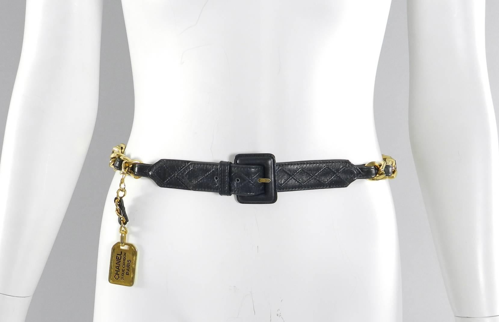 Chanel Vintage 1980's goldtone Chain Lambskin Leather Belt With Luggage Tag. Heavy gilt chain design with soft black lambskin leather and goldtone removable luggage chain drop. Marked Chanel on hook clasp and on luggage tag. Fastens at 20, 30, 31