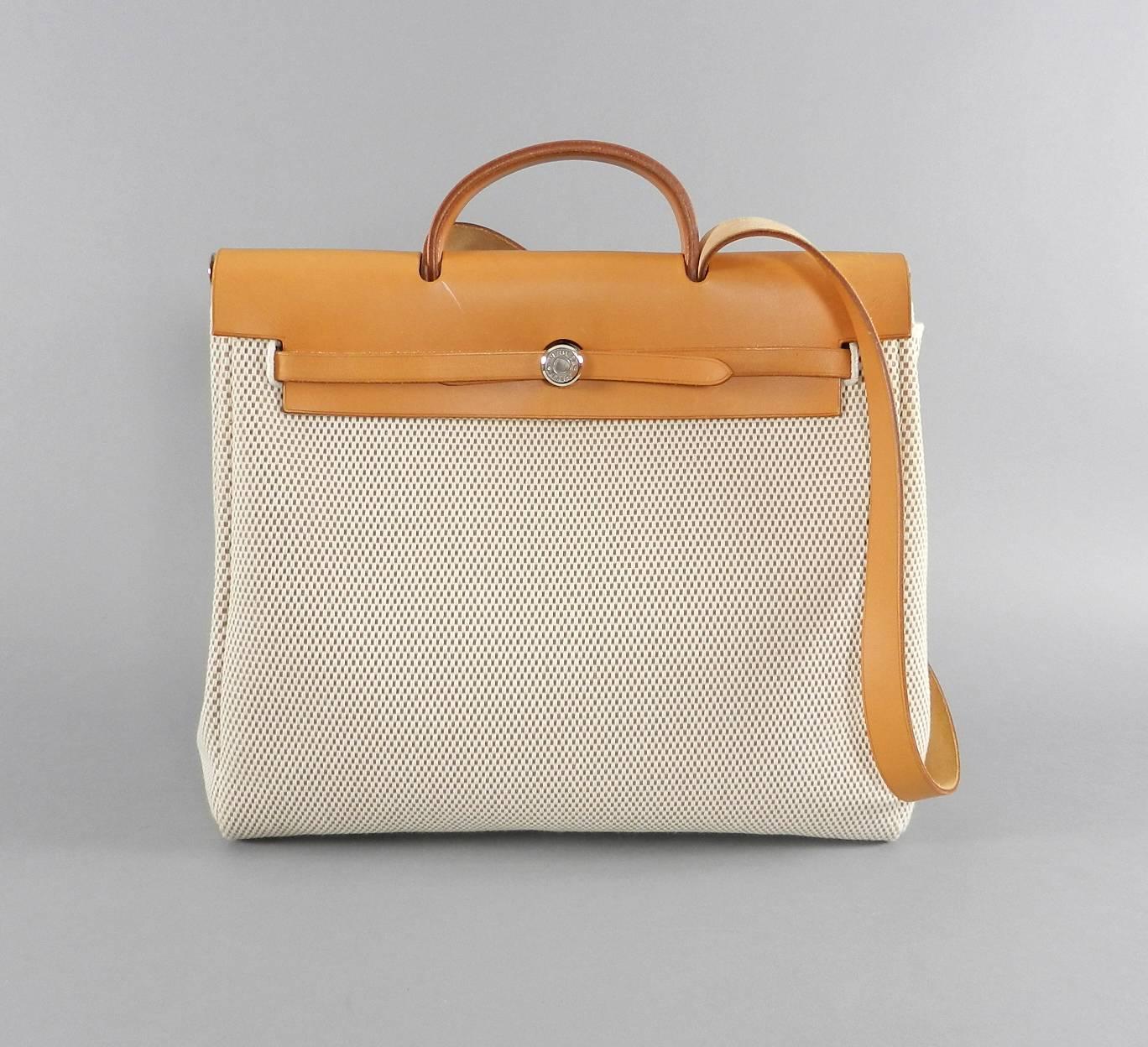 Hermes Herbag 2 in 1 Natural Toile MM.  Excellent pre-owned condition.  Toile bags are very clean interior and exterior. Natural leather top has 1 white mark across front near clasp (as pictured) and 3 faint watermarks (as pictured). Does not