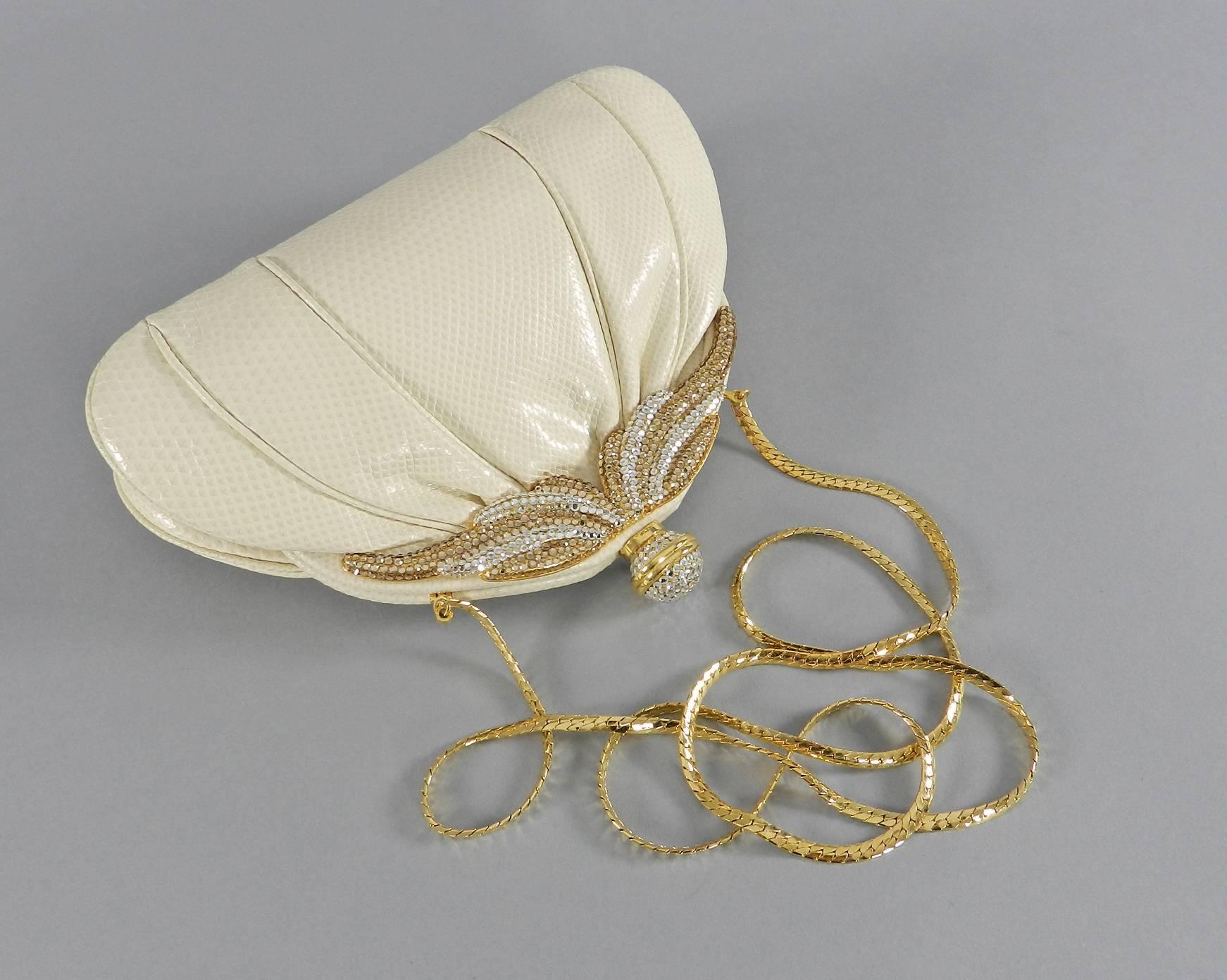 Vintage 1980's cream colored lizard evening bag. Goldtone frame embellished with topaz and clear swarovski crystals. Long goldtone chain shoulder strap can be tucked inside when used as clutch. Body of bag measures 8.5 x 5.5 x 2