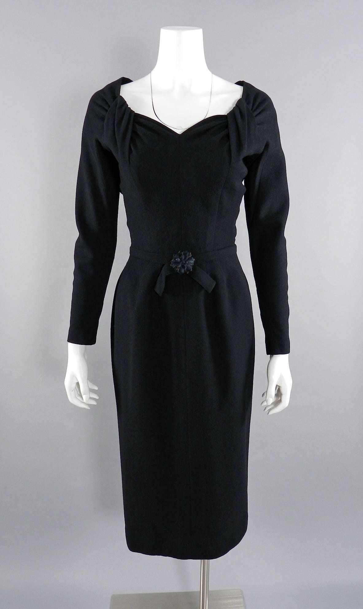 Vintage Jacques Fath dress and jacket suit. Circa 1950's.  Wool dress has a 25" waist, measures 37" at bust, and 39" at hip. Has a sweetheart neckline, flower at front waist, and metal back zipper. Jacket is straight-cut with large