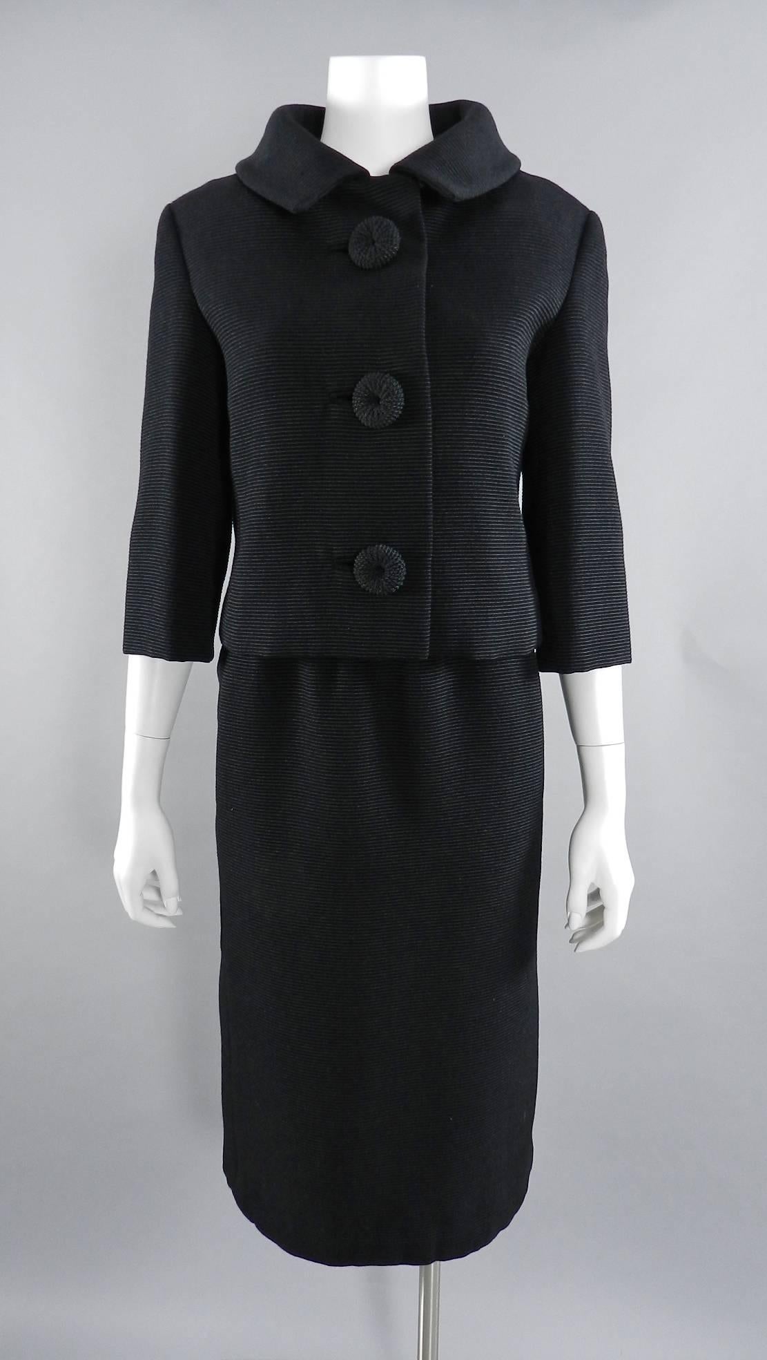Christian Dior circa 1960 black dress and jacket suit. Dior London Made in England label. Fine textured ribbed fabric with large statement buttons. Satin lined interior.  Dress measures 36" at bust (recommended for 35" bust person),