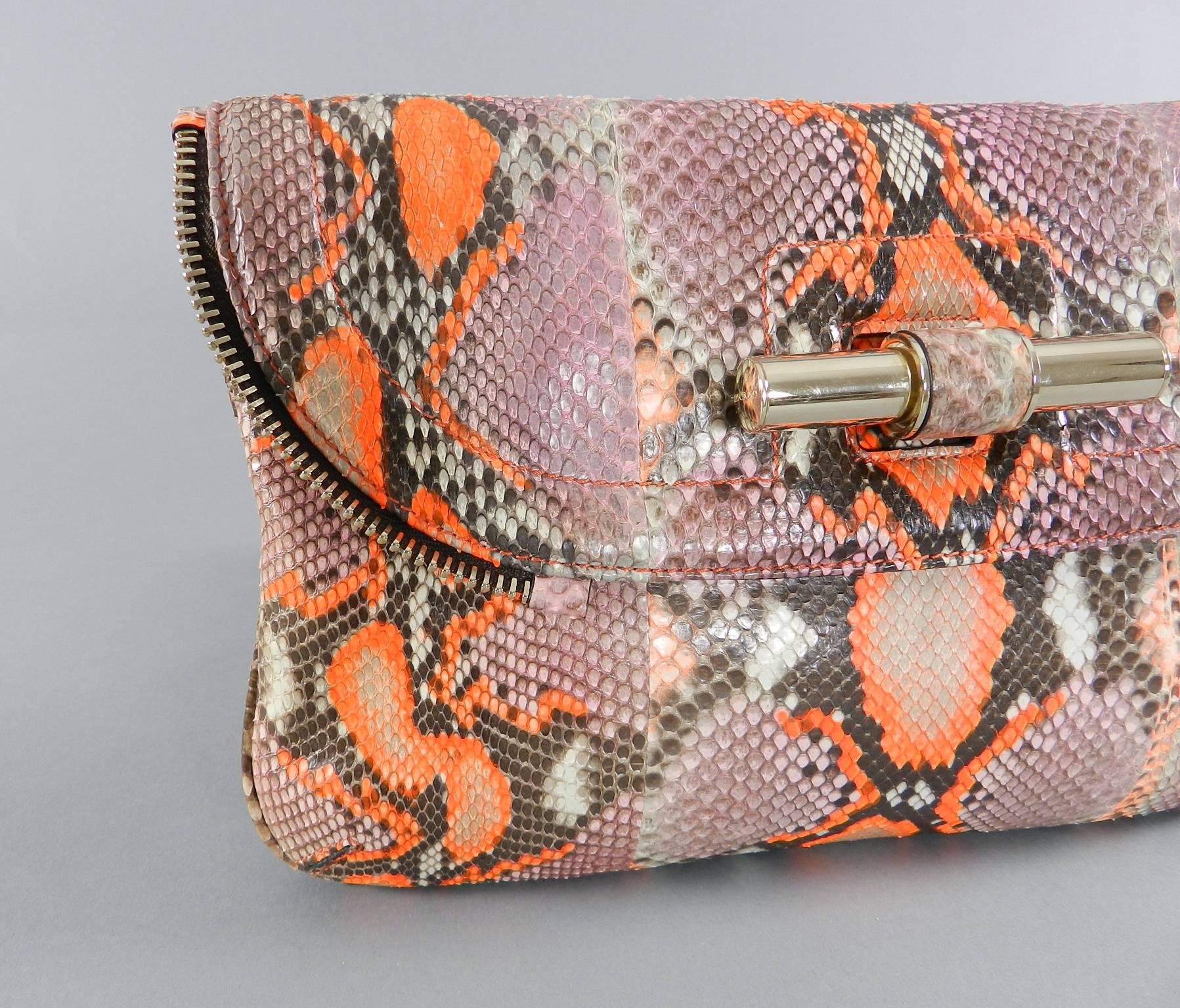Jimmy Choo Pink and Neon Orange Python Jasmine Clutch bag.  Goldtone metal hardware. Excellent clean condition and appears to have not been used. Body of bag measures about 11.5 x 7 x 1.5".  

We ship worldwide.