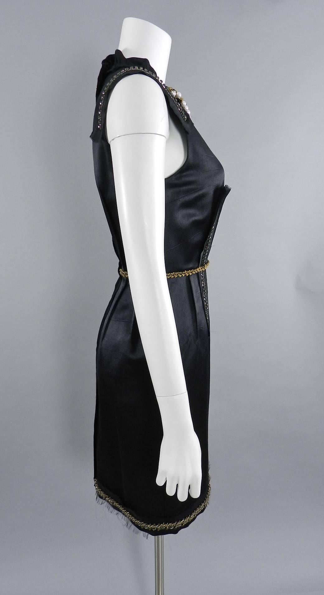 Lanvin Black Satin Cocktail Dress with Pearls and Chains.  2012 Anniversary Dix Ans label to commemorate designer Alber Albez' 10 years at Lanvin. Embellished with antiqued goldtone chains, pearls, and rhinestones. Excellent pre-owned condition.