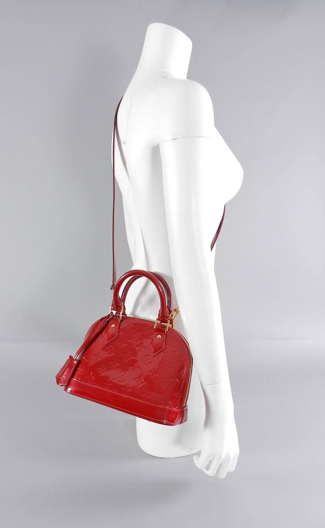 Louis Vuitton Alma BB in Cherry Vernis - mini size.  Excellent pre-owned - like new - worn once. Includes duster, strap, lock, clochette, 2 keys.  Date code reads SD3143. Body of bag measures 9.5 x 7 x 4.5" with a 22" drop strap.  

We