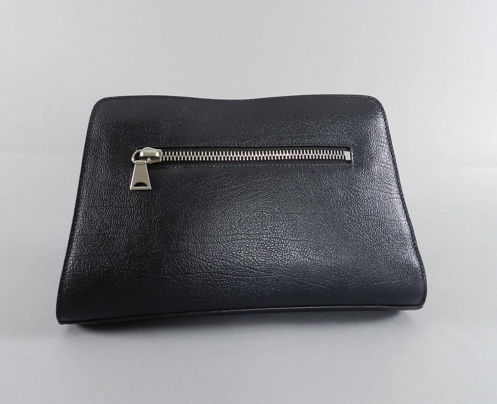 Proenza Schouler Black Clutch Bag with Silver Zipper.   Interior is lined with natural colored linen fabric. Excellent pre-owned clean condition.  Measures 11.75 x 7.5 x 2.75".

We ship worldwide.