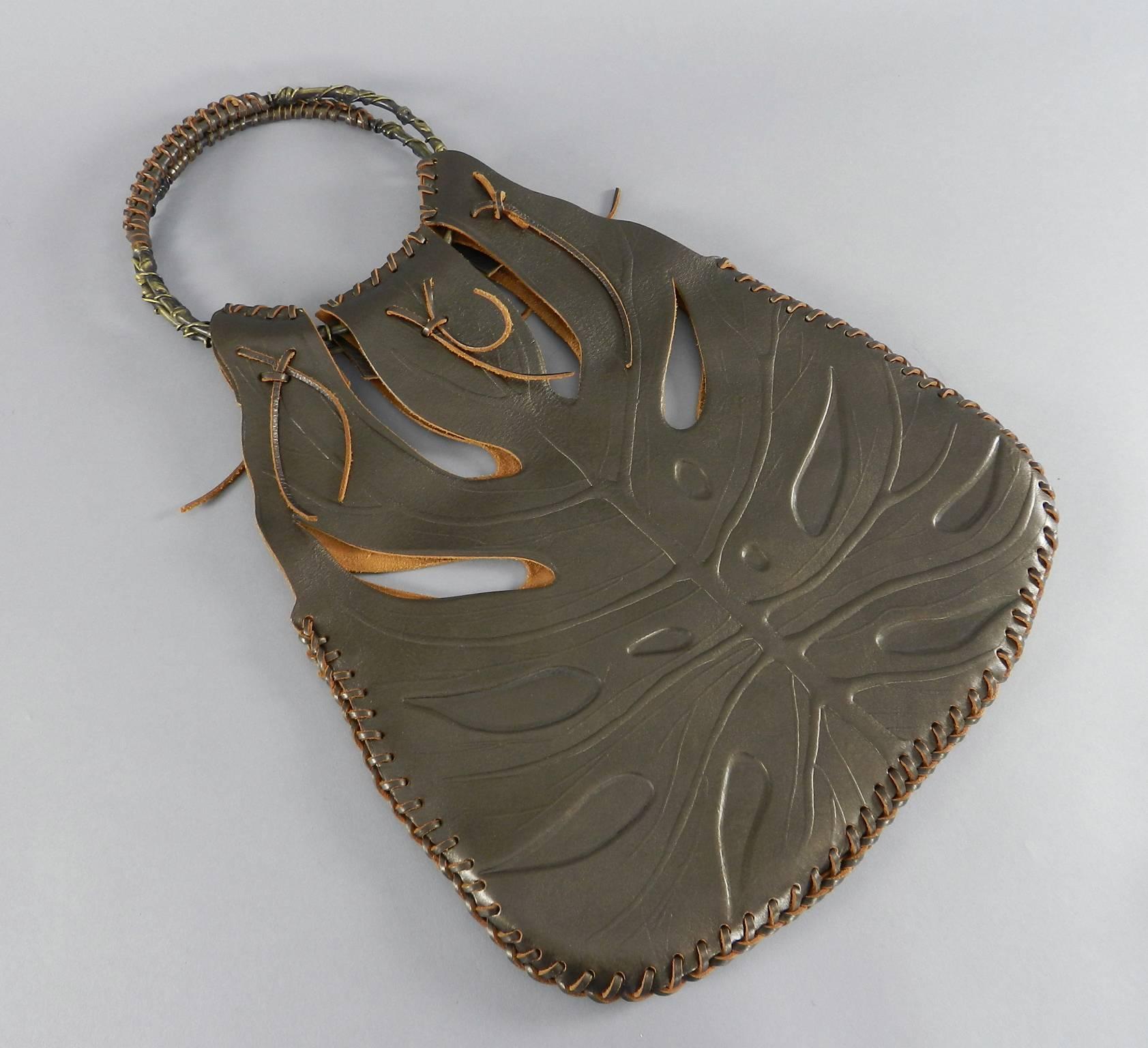 Valentino Brown Jungle Leaf Leather Bag with Metal Rings.  Dark brown stamped and perforated leather with raw leather interior. Excellent clean condition - like new. Includes duster. Body of bag not including rings measures 14.5 x 15 x 2