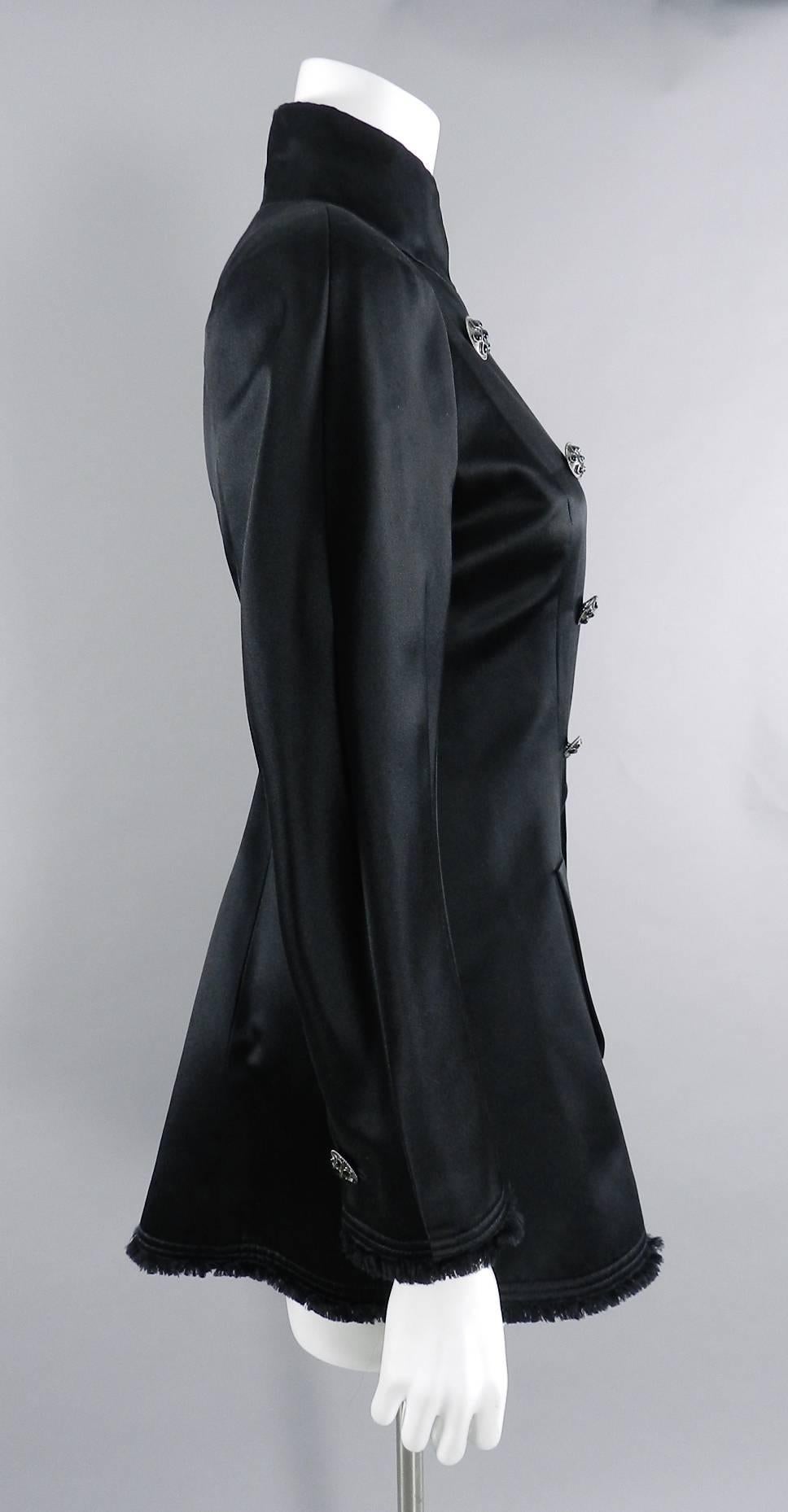Chanel 2008 fall black silk satin evening jacket. Fringed hem and cuffs, split panel at front bottom, side hip pockets, and black enamelled buttons. Size FR 40 (USA 8). Garment measures 37