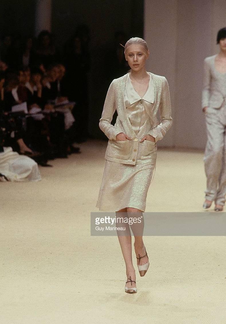 This Chanel skirt suit was look number 3 at the printemps - ete 1999 haute couture runway show in Paris.  Cream colored tweed fabric with irridescent shimmer weave that reflects green and pink tones. Jacket is lined with light mesh fabric, has