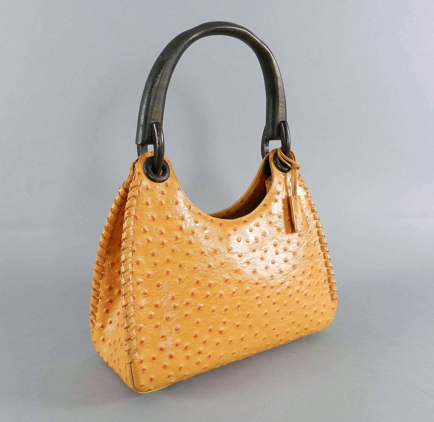 Gucci Ostrich Whipstitch Bag with Wood Handle.  Circa fall 2002 and designed by Tom Ford. Squash yellow / orange color with G jacquard black fabric lining. Excellent clean condition.  Body of bag measures 11.5