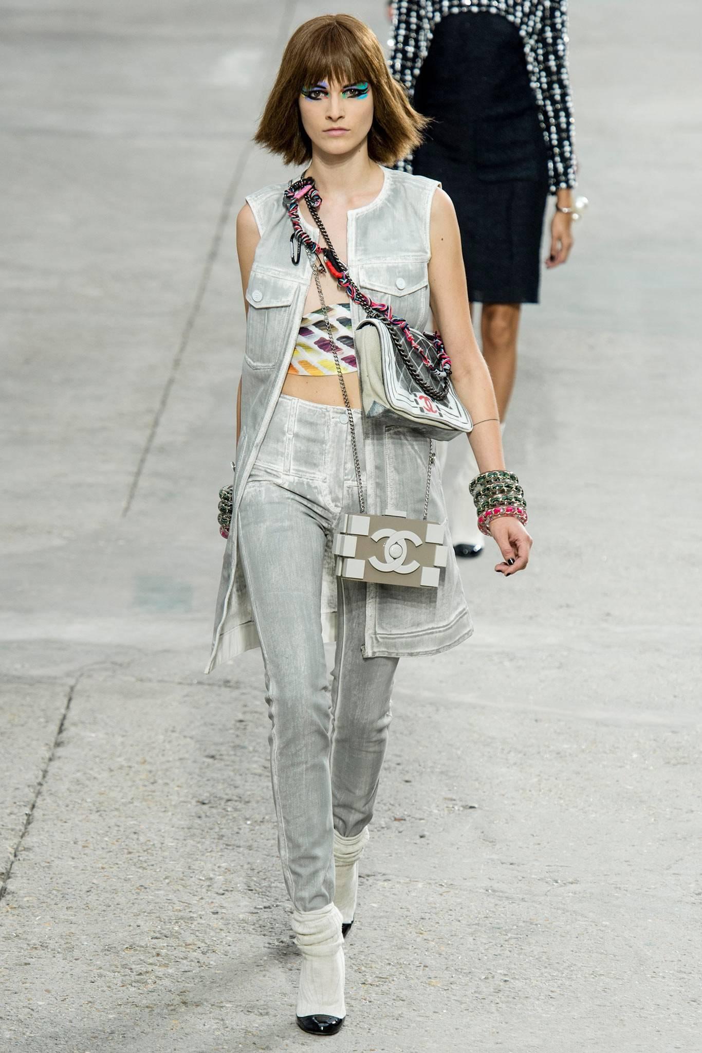 Chanel 2014 spring runway grey distressed denim long vest.  Light grey version was shown on the runway. Original retail price tag of $4600. Matching jeans are available in separate listing.  White denim base with dark charcoal grey.  Garment zippers