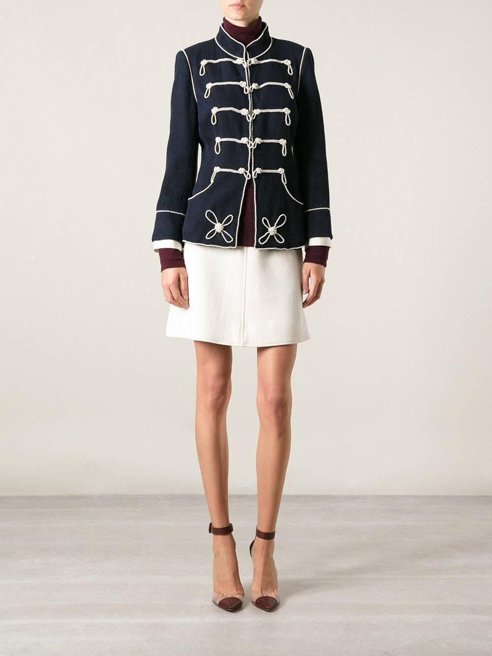 Chanel 09P Limited Edition Military Pearl Beaded Jacket and Skirt Suit.  Navy blue colored jacket is decorated with pearl beads and has removable ivory cuffs.  Skirt has high waistband, 2 inverted pleats at front, 1 inverted pleat at back, and