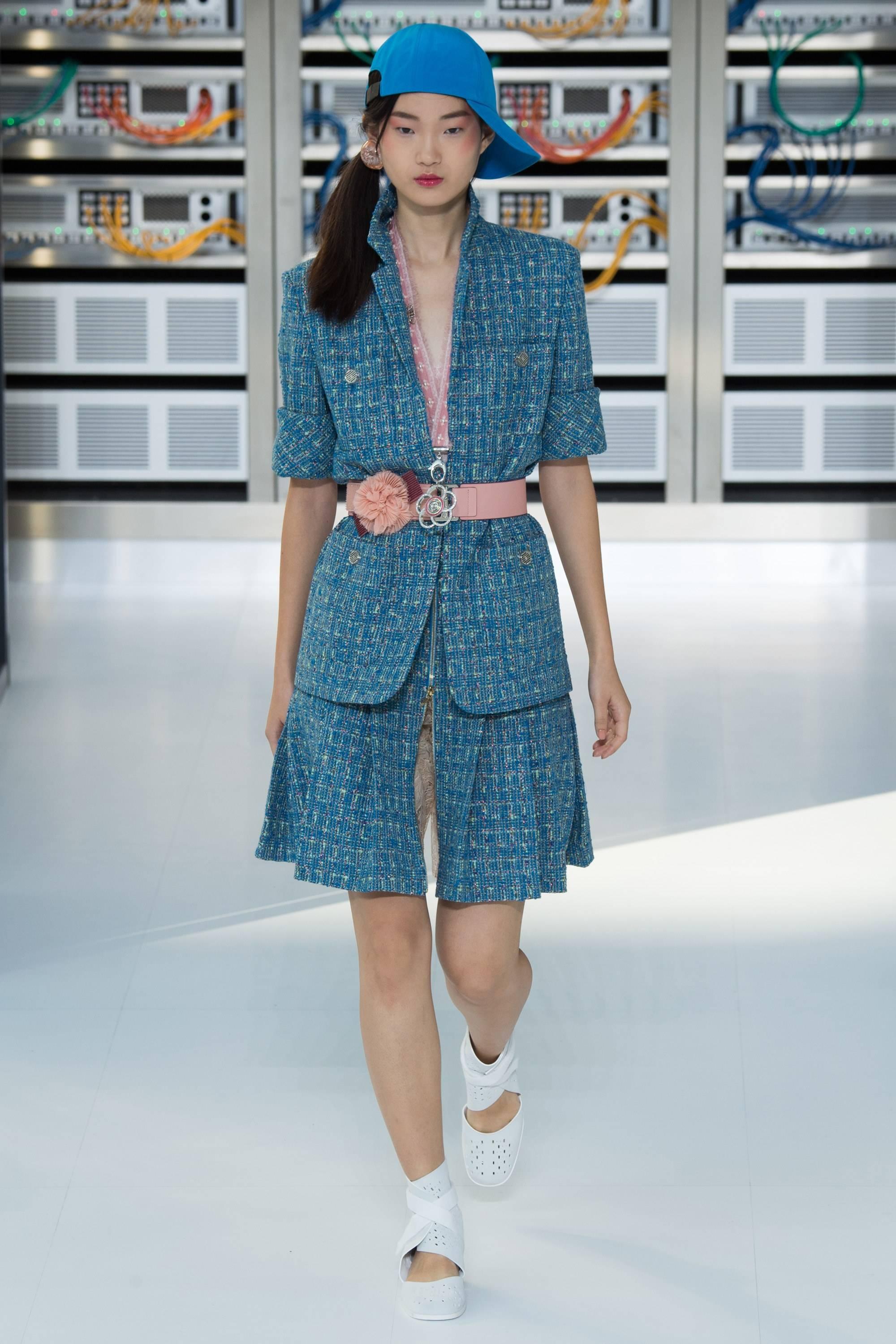 Chanel 17S -  2017 Spring runway Current Season Turquoise Blue Tweed Skirt Suit.  The tweed has green tones and fine metallic red threads. Jacket fastens at front with hidden hook and eye closures, has front chest and hip pockets, and silvertone