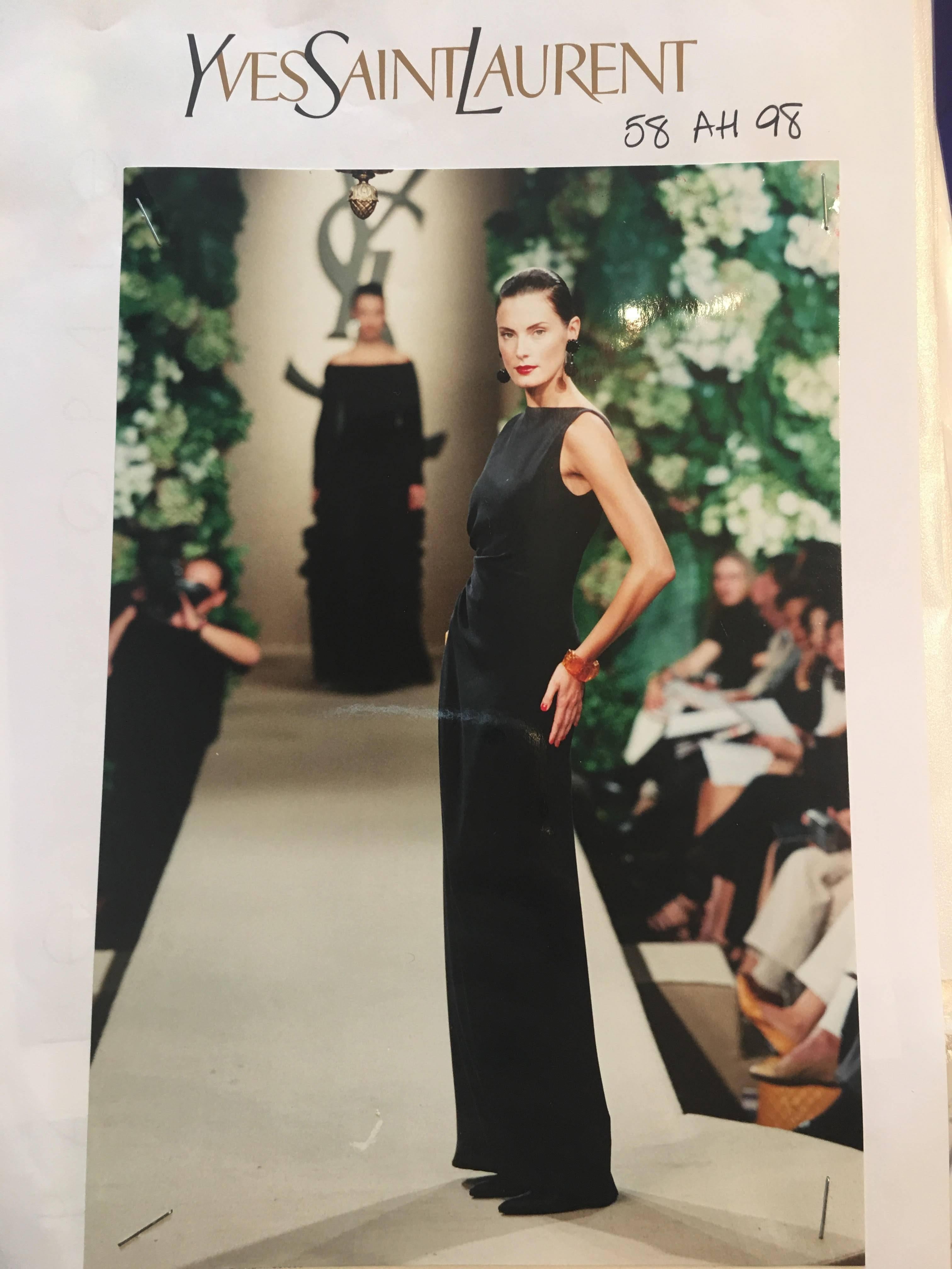 Yves Saint Laurent AW 1998 Haute Couture Black Low Back Evening Gown.   Haute couture archive runway photo included for reference.  Elegant column gown with low back, side bow, and wrap design at back. Fastens with hidden snaps and hook / eye