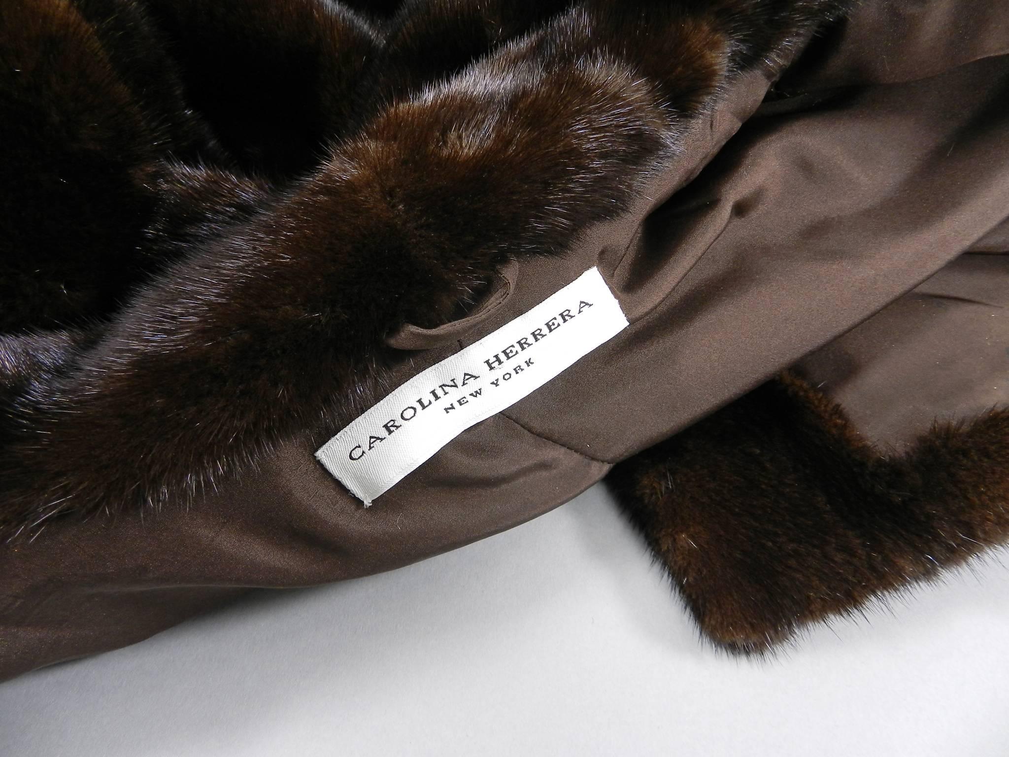 Carolina Herrera New York Dark Brown Mink Long Fur Coat. Fastens at front with 3 hidden fur clasp closures and another hook and eye closure when collar is worn up. Folded up cuffs, hidden side pockets. 

Approximate overall size USA 10. Garment