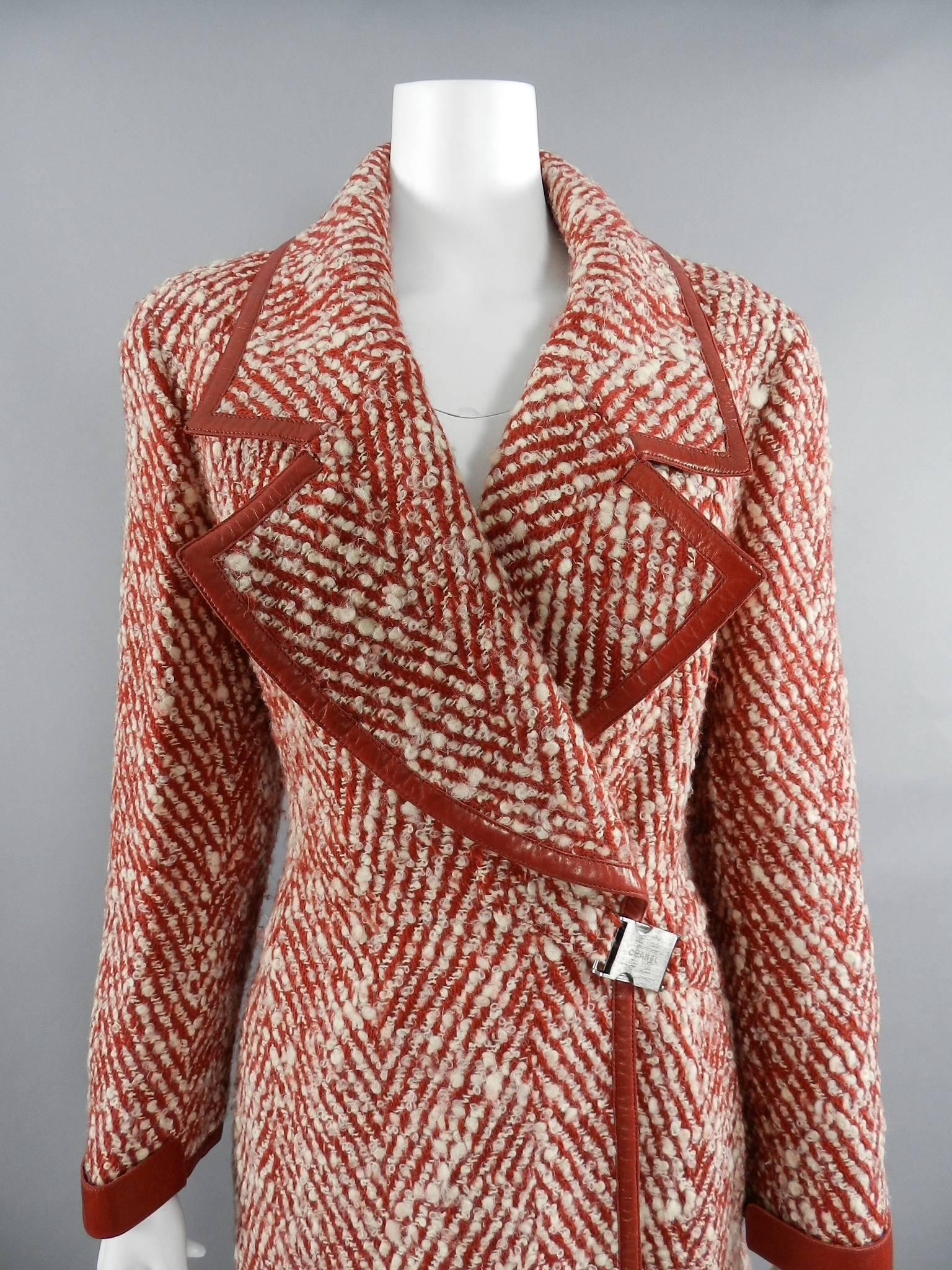 Chanel red and ivory boucle tweed wool coat.  Trimmed with leather and fastens at left side waist with logo buckle. Lined in ivory jacquard CC logo silk. From the fall 2000 collection.  Very heavy wool full-length coat.  Tagged size FR 44 (USA 10 /