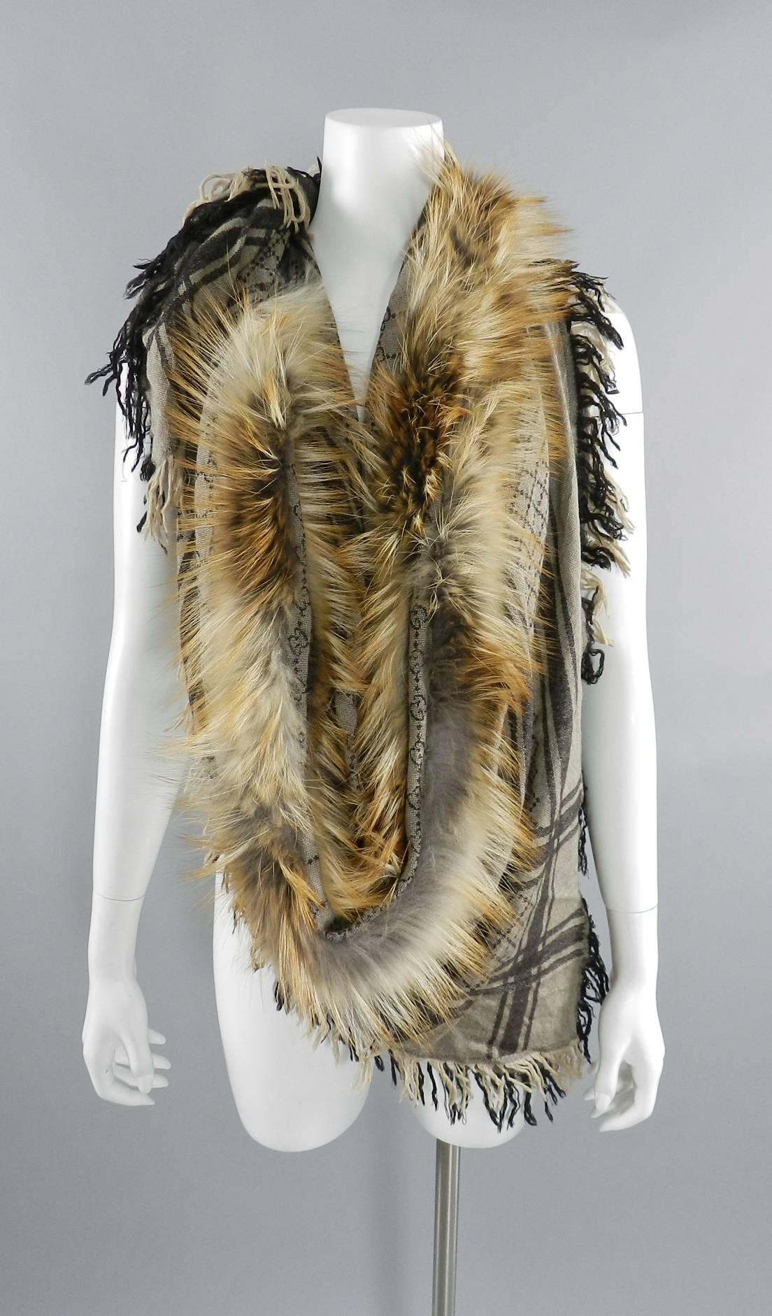Gucci Brown GG Logo Large Shawl Wrap with Fox Fur Trim.  70% wool, 30% silk. Includes box pictured. 50" x 50" not including fringe. Excellent pre-owned with a few runs / snags. Does not detract when worn.

We ship worldwide.