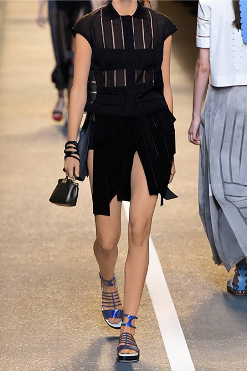 Fendi black micro peekaboo crossbody bag from the spring summer 2015 runway show.  Goldtone hardware, suede lined interior, long thin leather strap.  Body of bag measures about 6 x 4.25 x 2.25".  Original retail price $1550 USD new.