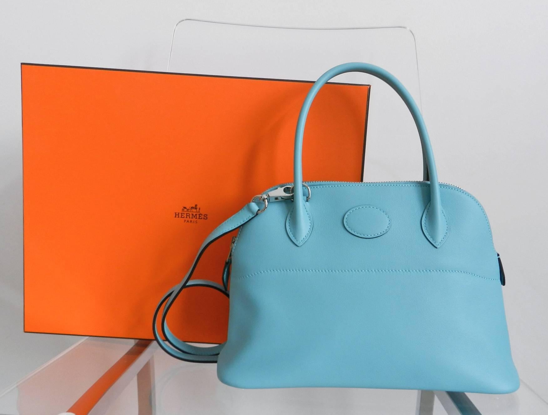 Hermes bolide 27cm in vibrant turquoise blue atoll.  Soft veau sombrero leather and palladium hardware.  Fully outfitted with strap, duster, strap duster, raincoat, and original purchase receipt. Excellent pre-owned condition - carried once. Date