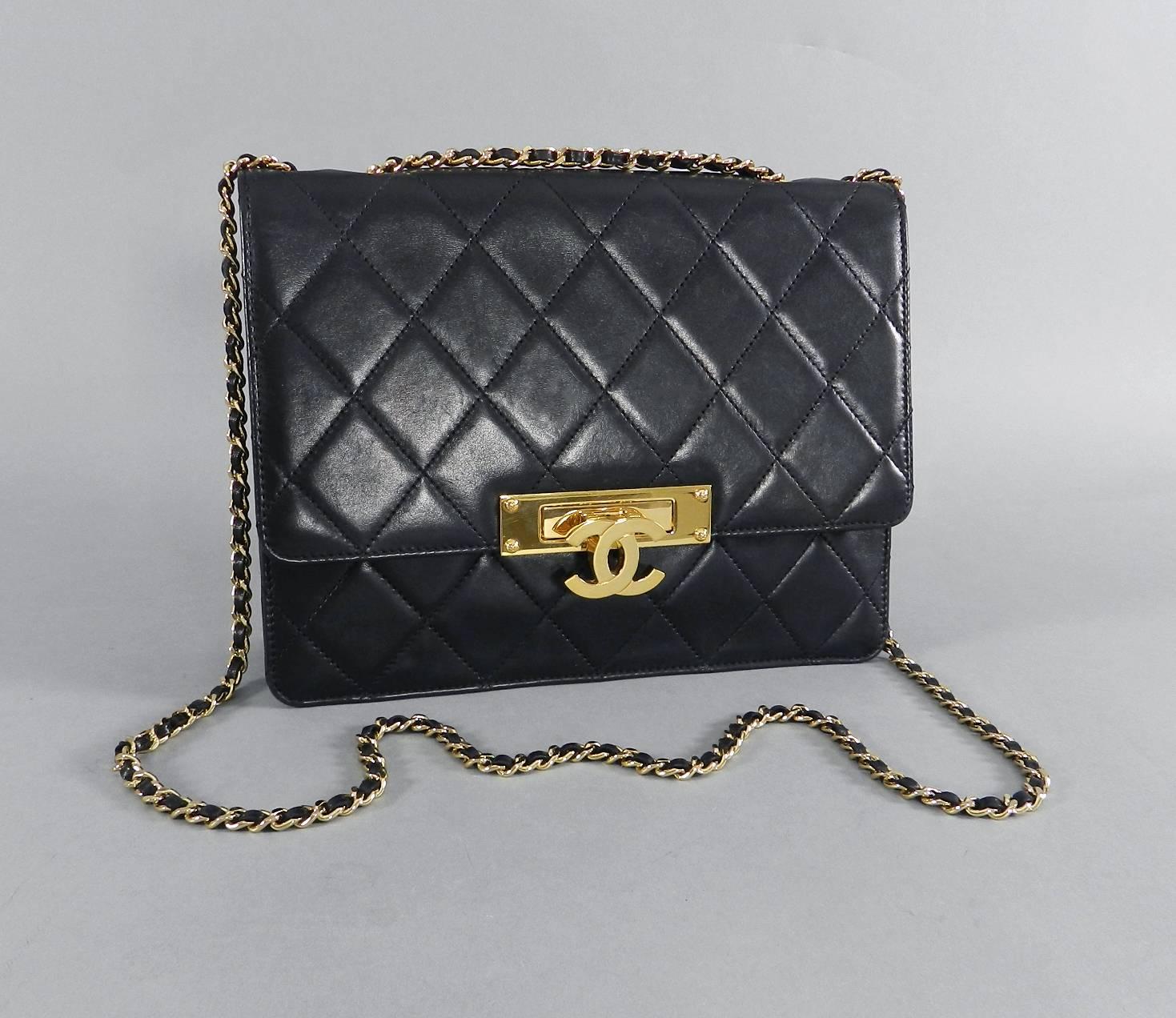 Chanel Black Lambskin Quilted Golden Class Flap Bag from the Cruise 2014 collection.  The bag features a bold Goldtone CC logo fold-down clasp and is lined with burgundy satin fabric. Size medium measuring 9.5 x 7.25 x 2.75".  Strap drop is