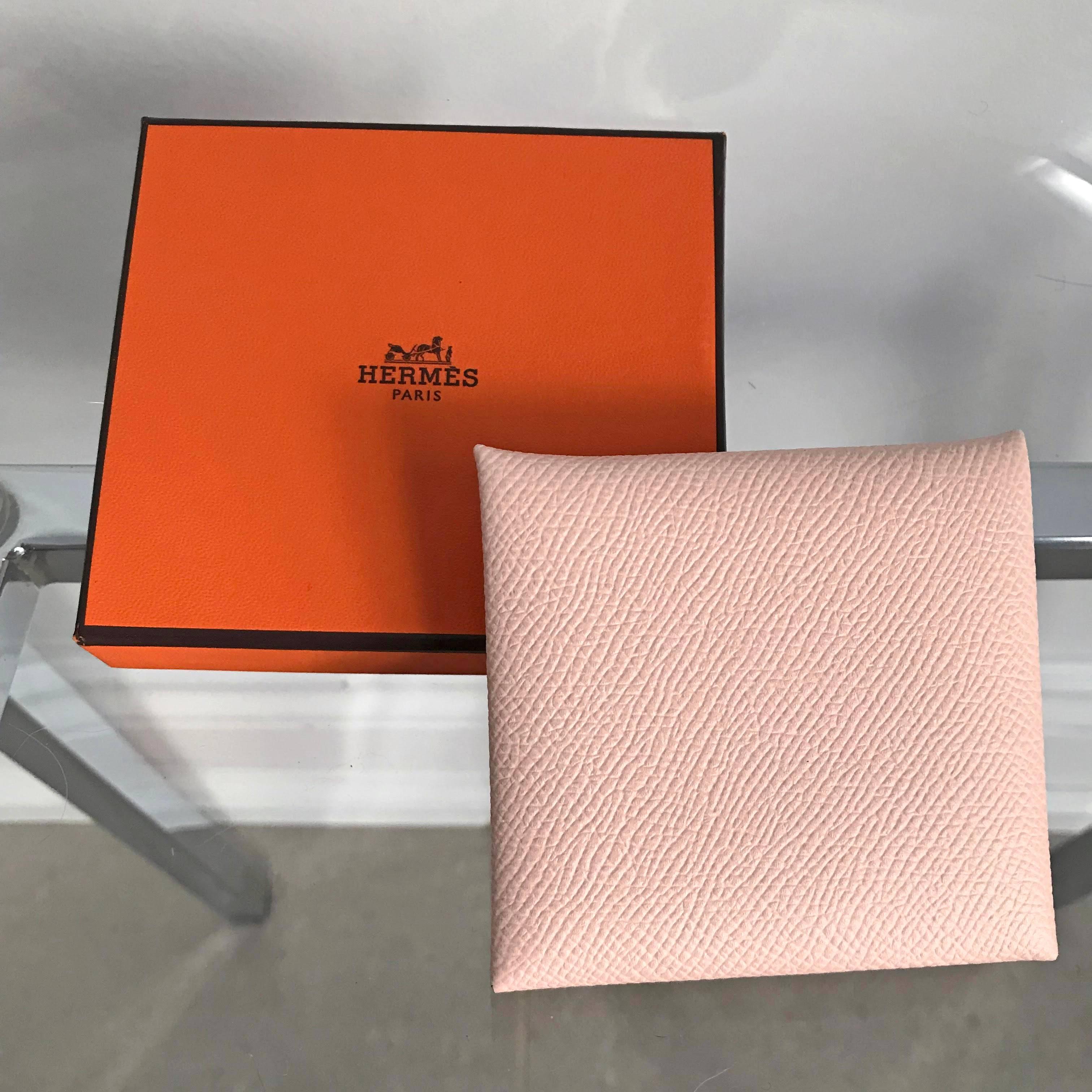 Hermes Bastia coin holder purse.  Square shaped fold over coin pouch that fastens with snap closure.  Epsom leather in light blush pink Rose Eglantine color.  Date stamp X for production year 2016.  Includes box.  Excellent condition - used once if