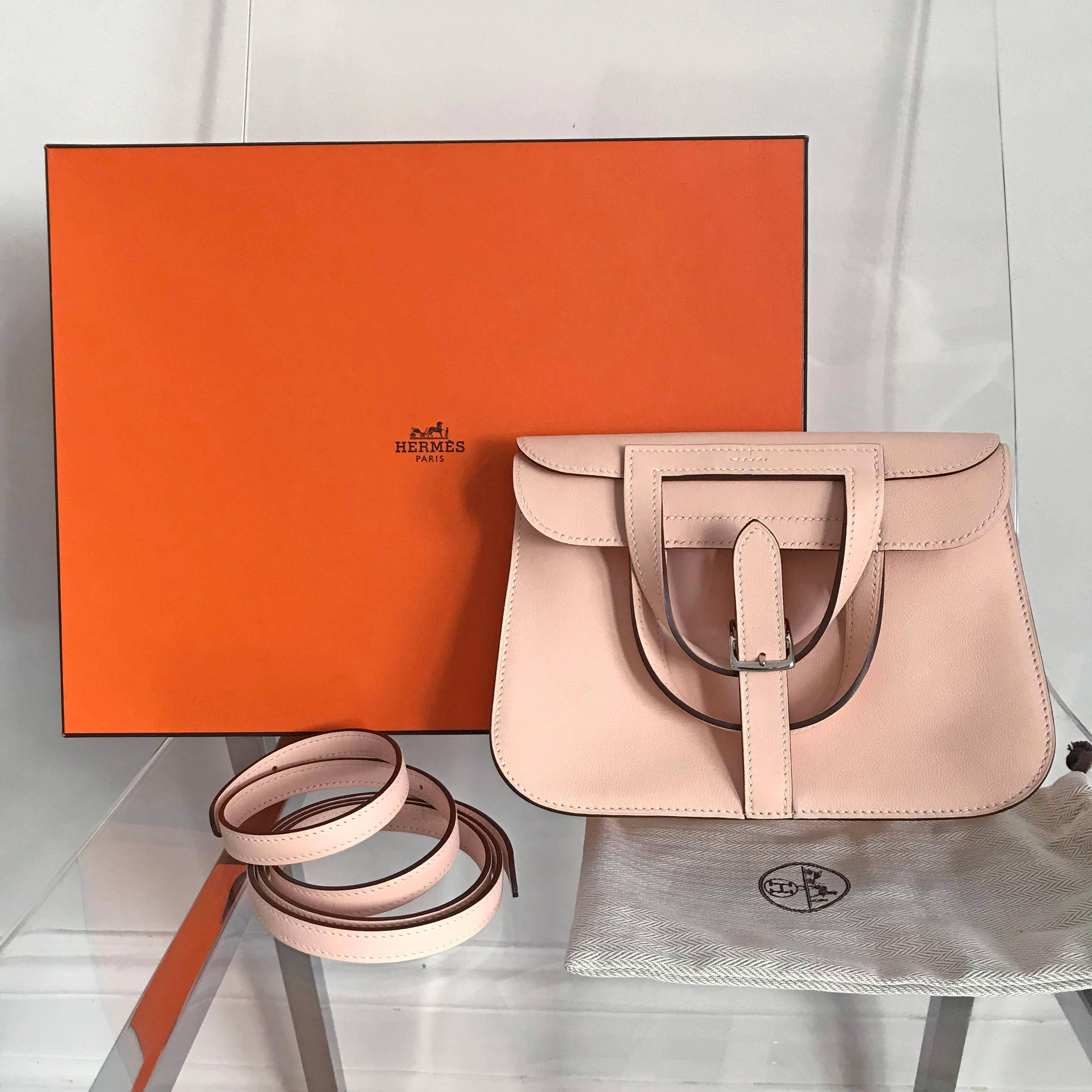 Hermes Halzan mini 22cm bag.  Smooth swift leather, light blush pink Rose Eglantine color, palladium hardware.  Mini size measuring 22 x 15 x 6.5 cm.  The Halzan is a 4-way bag that can be worn and carried in various ways as pictured. Received as a