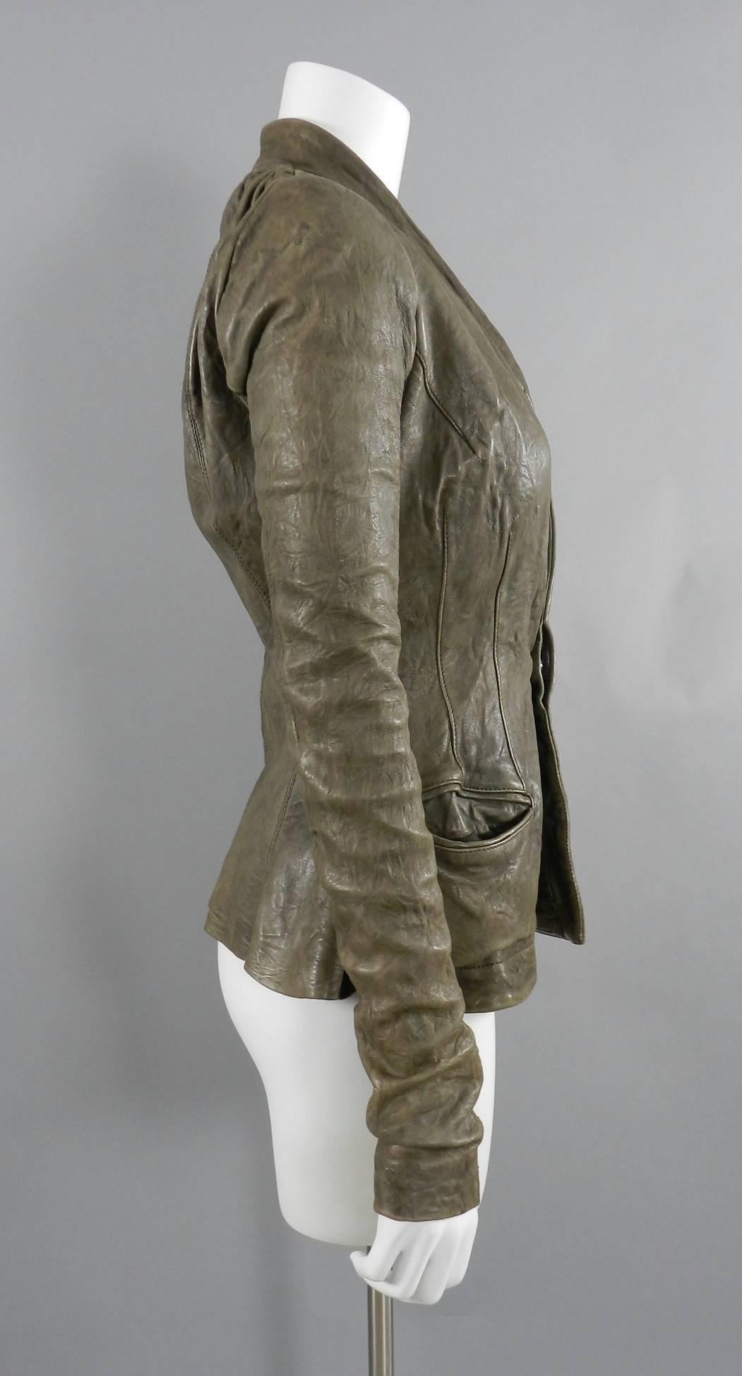 Rick Owens taupe distressed leather jacket. Jacket features extra long half knit sleeves that are worn gathered, fitted waistline, and side hip pockets.  Distressed wrinkled washed leather. Excellent pre-owned condition with about 1
