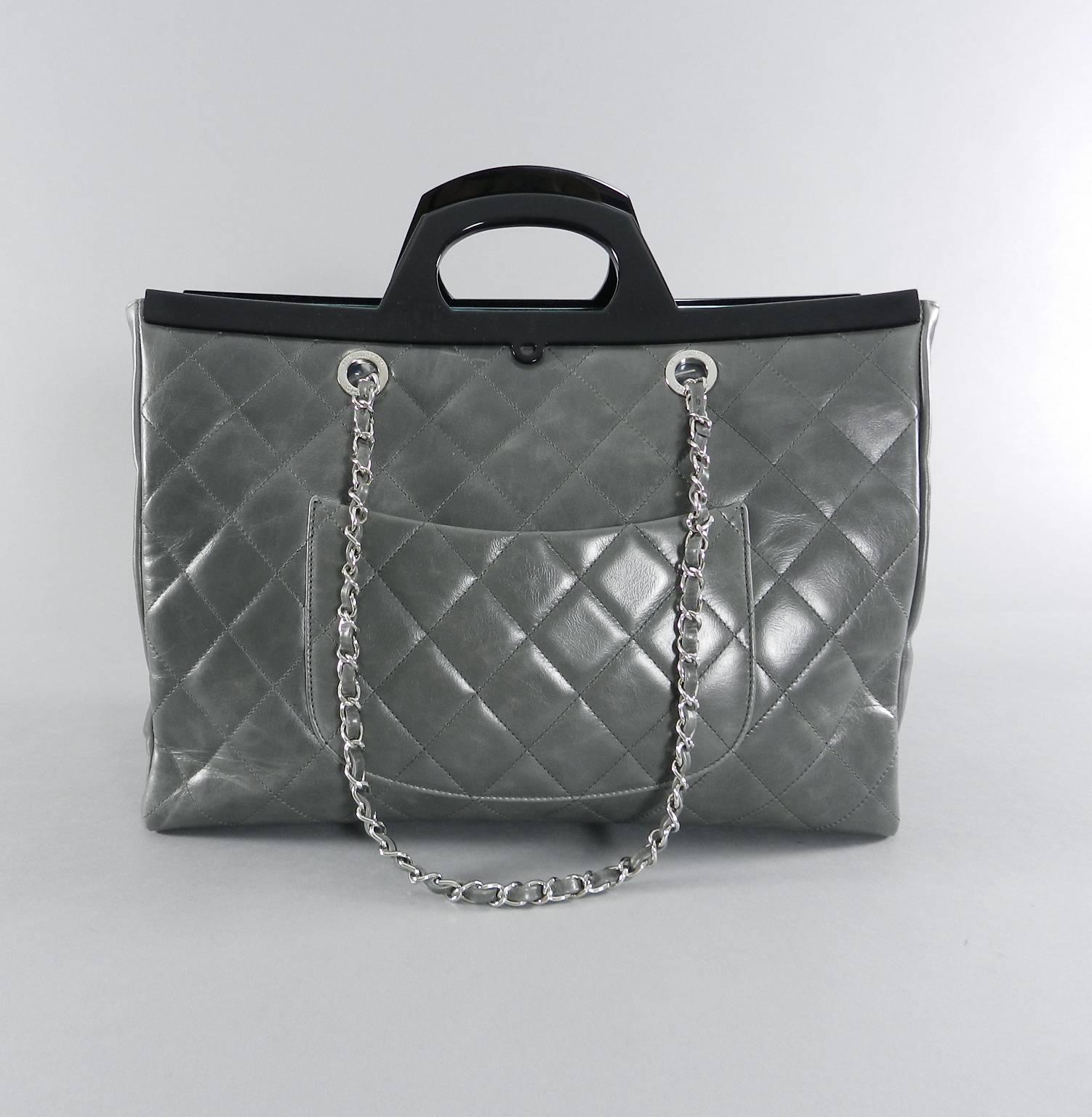 Chanel Fall 2014 Large Grey CC Delivery Shopping Tote Bag.  Large size quilted tote bag with  plastic frame and handle design and double chain straps. Small pocket on reverse and small compartment at front with cc turn clasp. Body measures 15 x 10.2