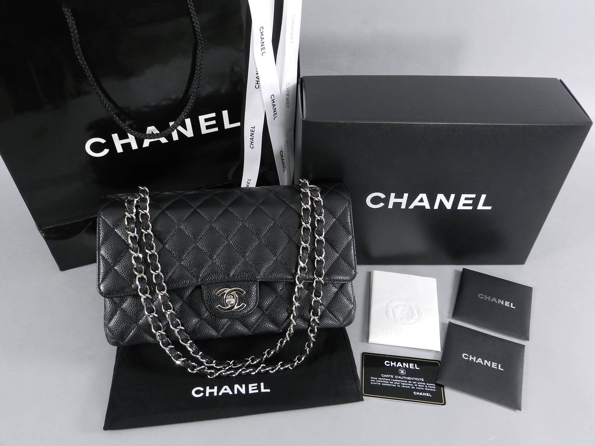CHANEL Classic Double Flap 2.55 Medium Bag. Black caviar leather with all black leather interior. Silvertone metal hardware.  Double flap design with quilted CC logo on interior.  Medium size style number A01112 measuring 10