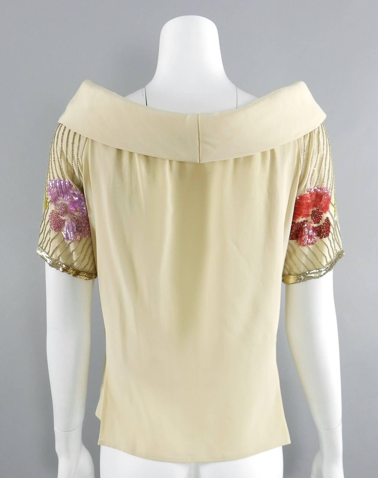Chloe Vintage 1970's Beige  Sequin Beaded Silk Top.  Wide scoop neck design with padded collar.  Sleeves are decorated with sequins and floral beaded design. Garment is pleated at back and darted at centre back waist. Size tag is not present but