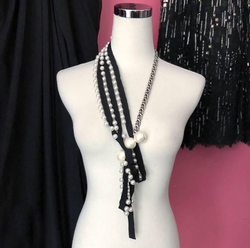 Lanvin Pearl and Ribbon Chain Necklace with Rhinestones.  Antiqued Matte silvertone metal curb chain and toggle clasp.  Large faux pearls and smaller pearl charms on black grosgrain ribbon.  Measures 12” drop (24” total length) with an additional 8”