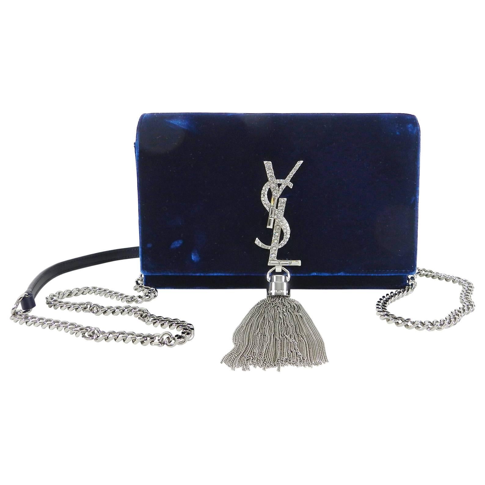 Saint Laurent Kate Tassel Blue Velvet and Rhinestone Crossbody Bag.  100% viscose velvet with silver-toned hardware and crystal embellishment on YSL logo. Magnetic snap closure, 1 bill compartment, 6 card slots and 1 zip coin pocket. Body of bag