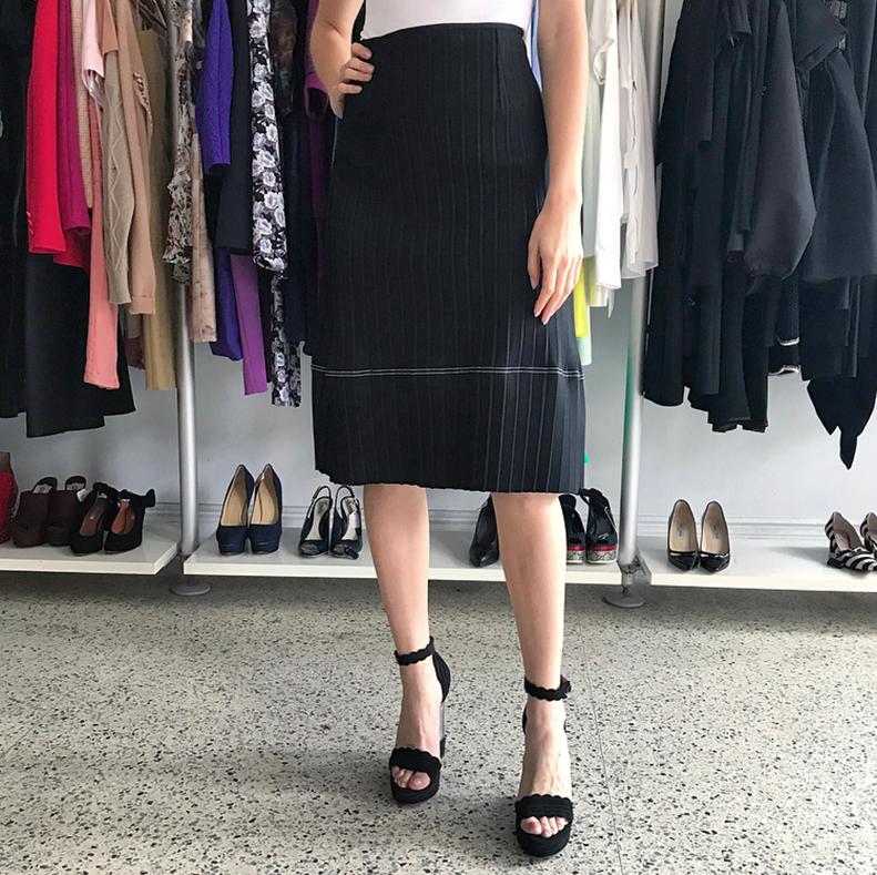 Celine Black Flat Pleat A-Line skirt.  Original retail price-tag of $2750 from Saks Fifth Avenue attached.  Knit plisse vertical pleats,  below knee length,  white top stitch accent.  Marked size M.  To fit USA 6/8.  Garment measures 31” at waist