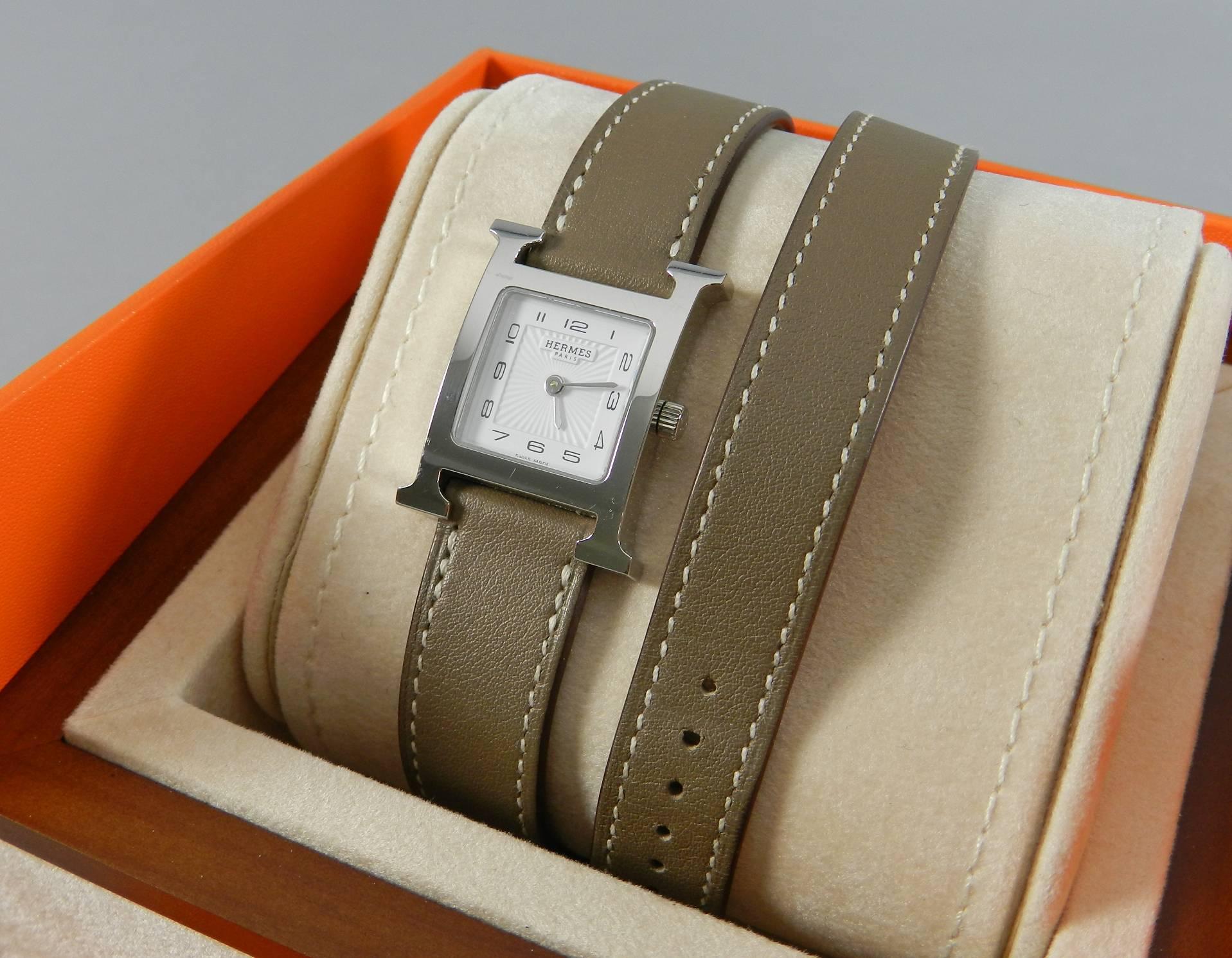 Hermes H Hour double tour PM watch.  Small PM size with front face measuring 21 x 21 mm not including points of the H.  Original box and papers and proof of purchase in 08/14.  Date stamp Q in box for year 2013.  Excellent pre-owned condition.