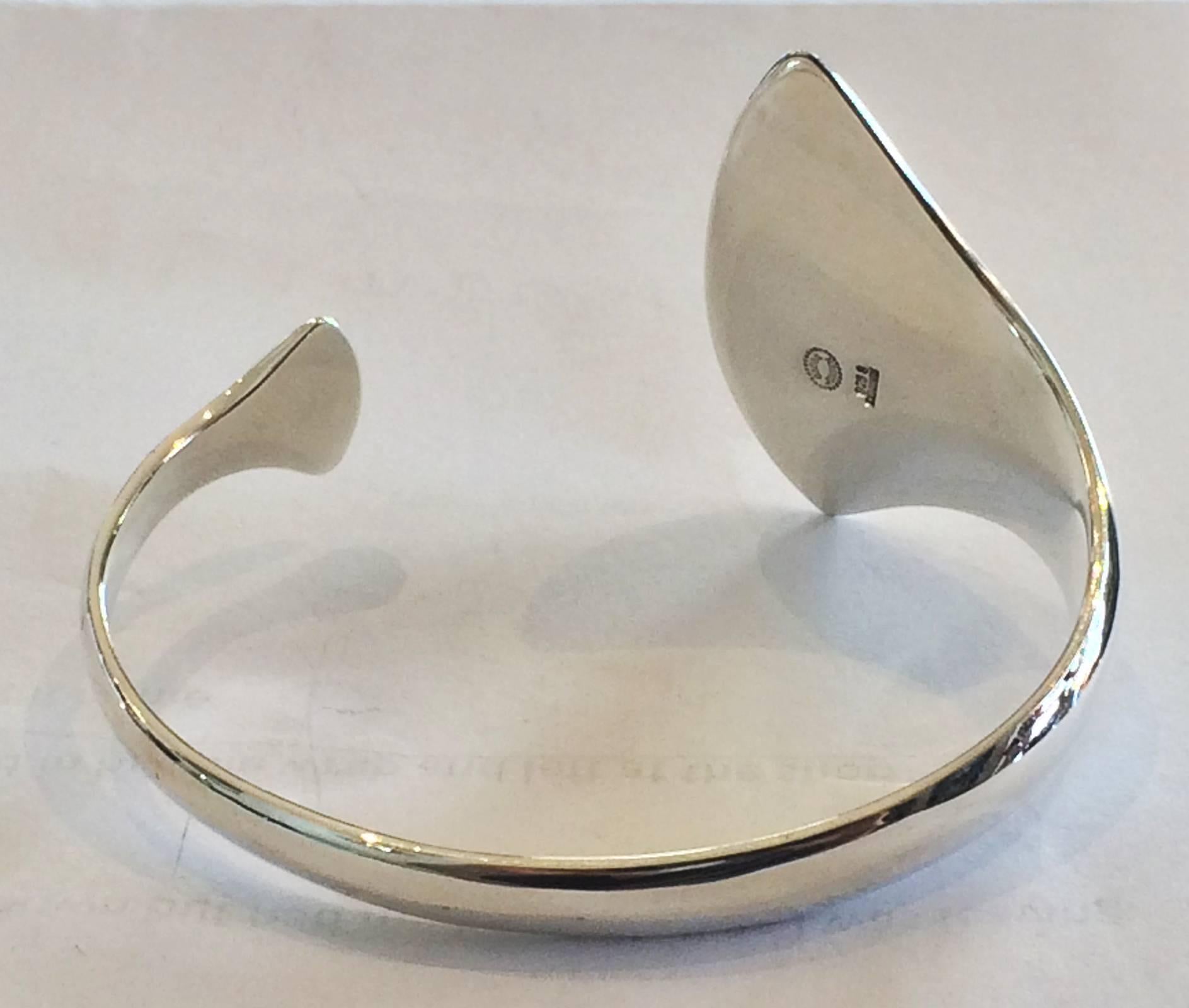 An unusual Georg Jensen cuff bracelet design by Hans Hansen and Bent Gabrielsen  in the 1960s/1970s era.  Design No. 214, marked with Post 1945 marks, Denmark 925s.  Size: diameter 6,0 cm / W max. 4,2 cm