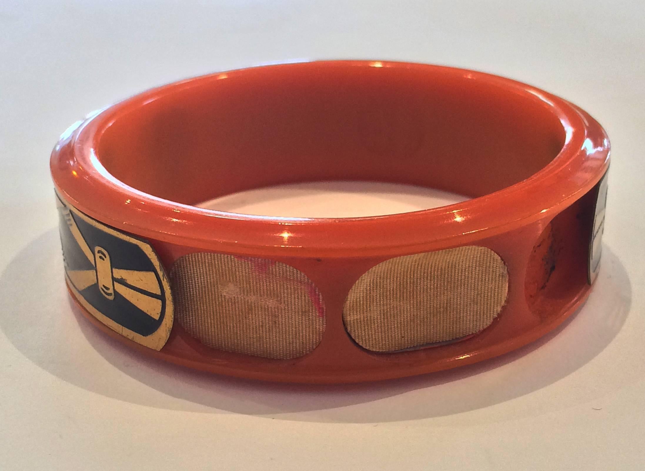Art Deco Make-Up Bangle in Orange Bakelite, with Gilt and black enamel, sliding Cover Band. A great invention so you would always be with your “Make-Up” kit. When “closed” none of the compartments are exposed, and it is then, just a decorarive