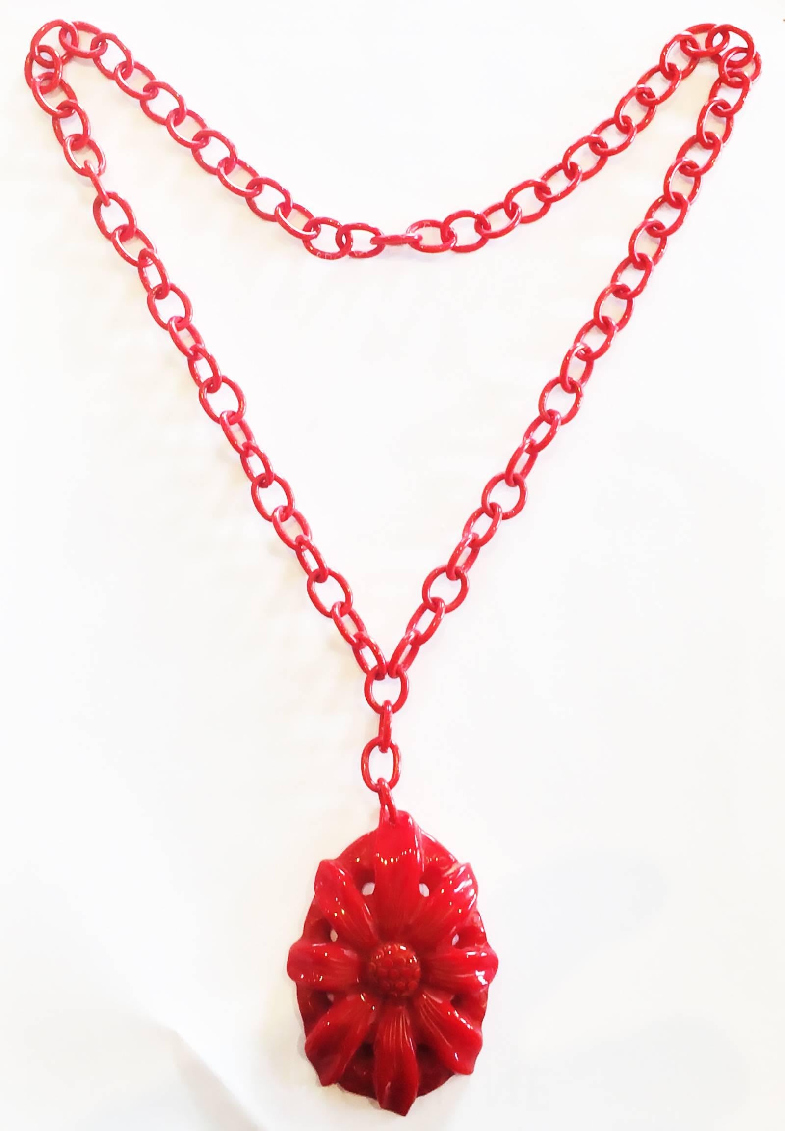 Art Deco Necklace with large Pendant of Brilliant Red Bakelite, heavily carved with a Daisy to the pendant, and still with its perfect, matching red, Celluloid chain. No damage or restoration to Pendant or Chain all in original condition (no metal