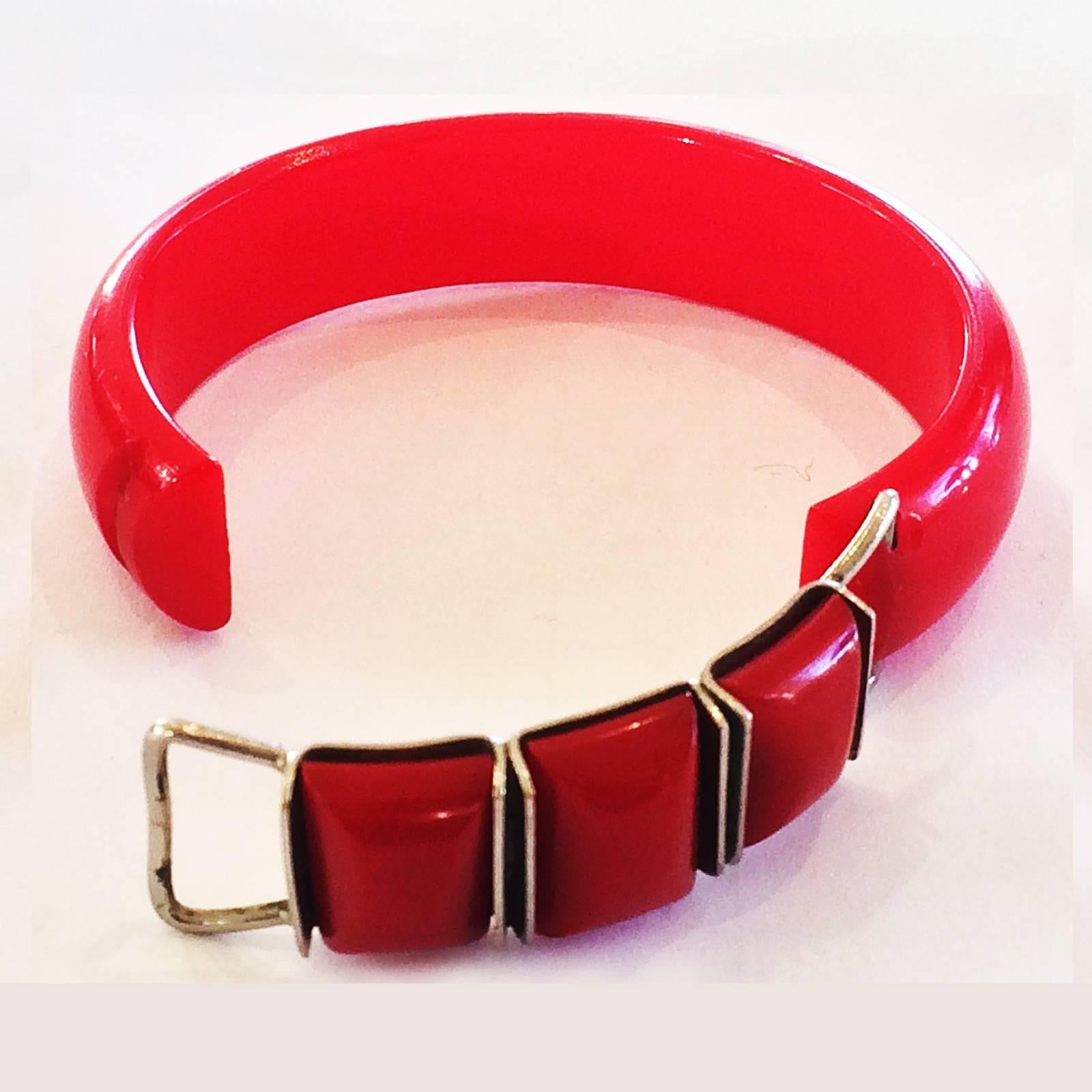 Art Deco Bangle in bright Lipstick  Red coloured Bakelite, with chromed “buckles” for decoration and also the clasp to open to place on your wrist. Very rare design with this operation. All in perfect condition, with no damage, repairs or losses at