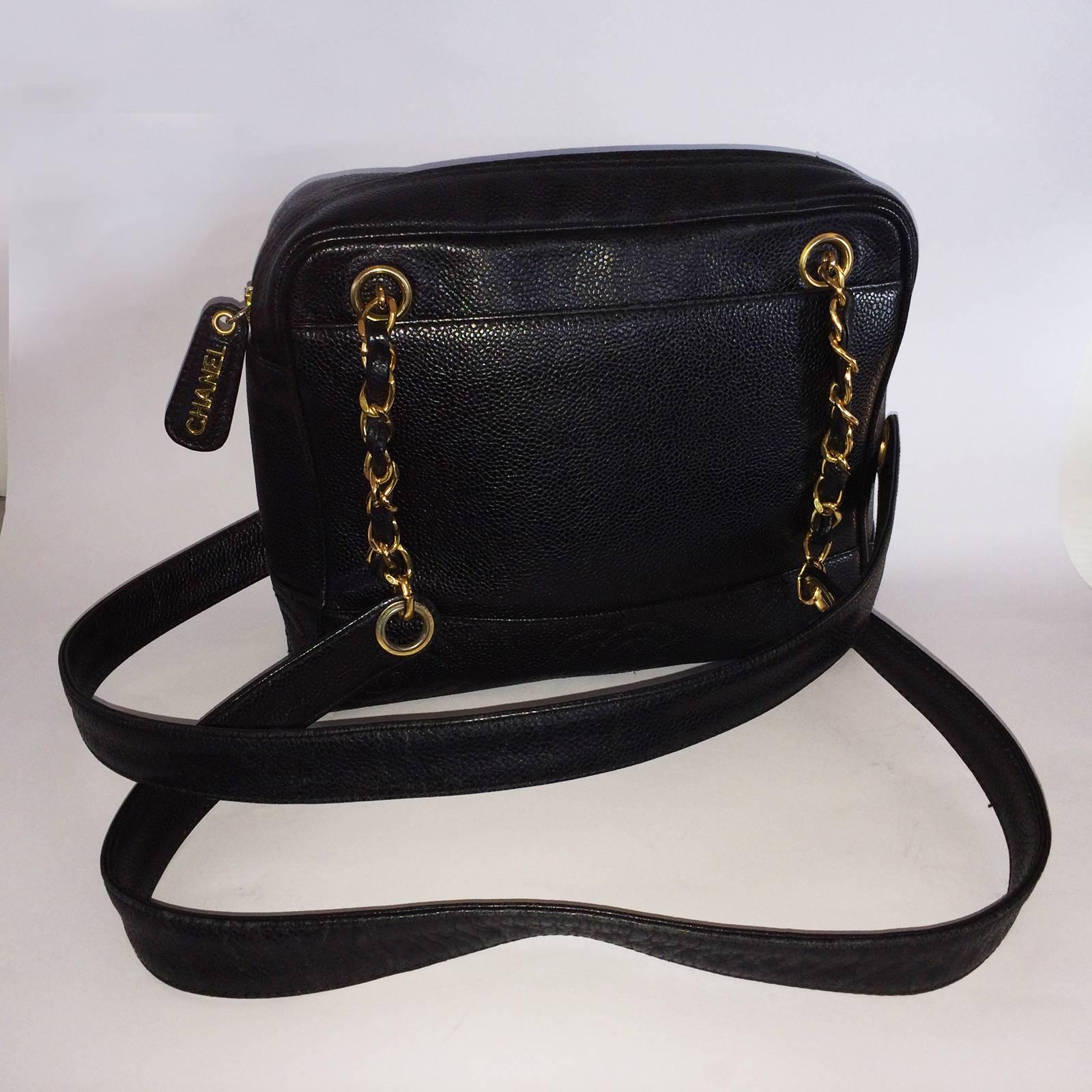 Chanel Handbag in Black Caviar Leather of medium proportions, having a large, exterior deep pocket to front and rear with gilt detail to 4 chains threaded with leather also and longer, shoulder straps to both sides. There is a full “CHANEL” badge to