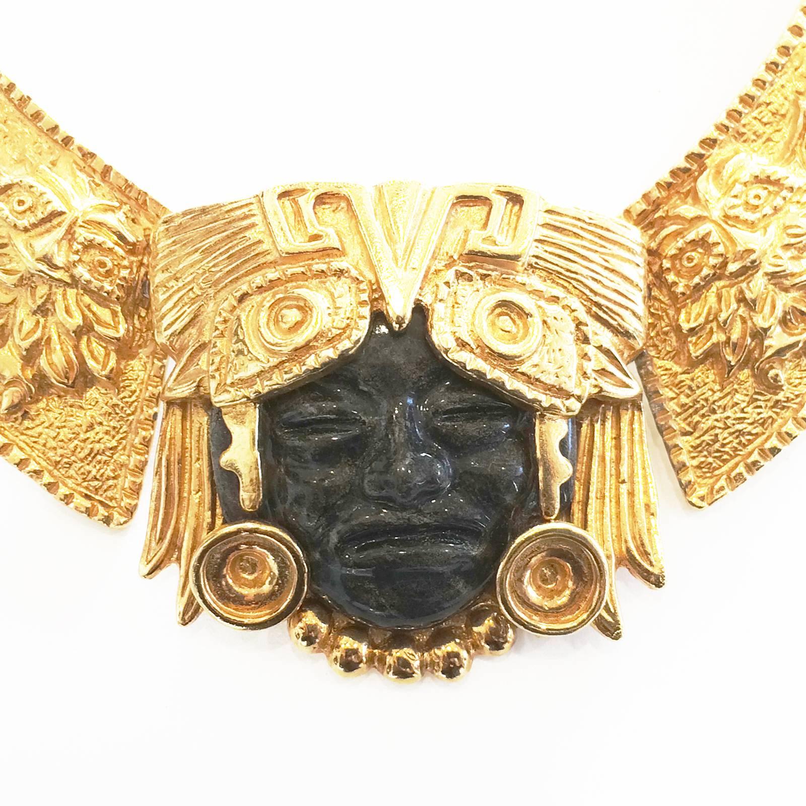 Mid Century Mask Necklace by Marbel Salvador, signed to the rear metal. An amazing high quality piece in an “Aztec” influence design with stylised face in glass and enclosure of Golden Headdress and surrounding, tapering links with “flowers and