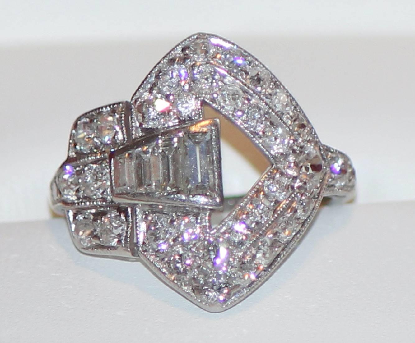 Beautiful original American art deco diamond ring from the F. W. Drosten Jewelery Company of St Louis, Missouri.  The ring consists of four baguette and thirty-four round old mine cut diamonds set in a stunning and unique platinum setting.

Here’s