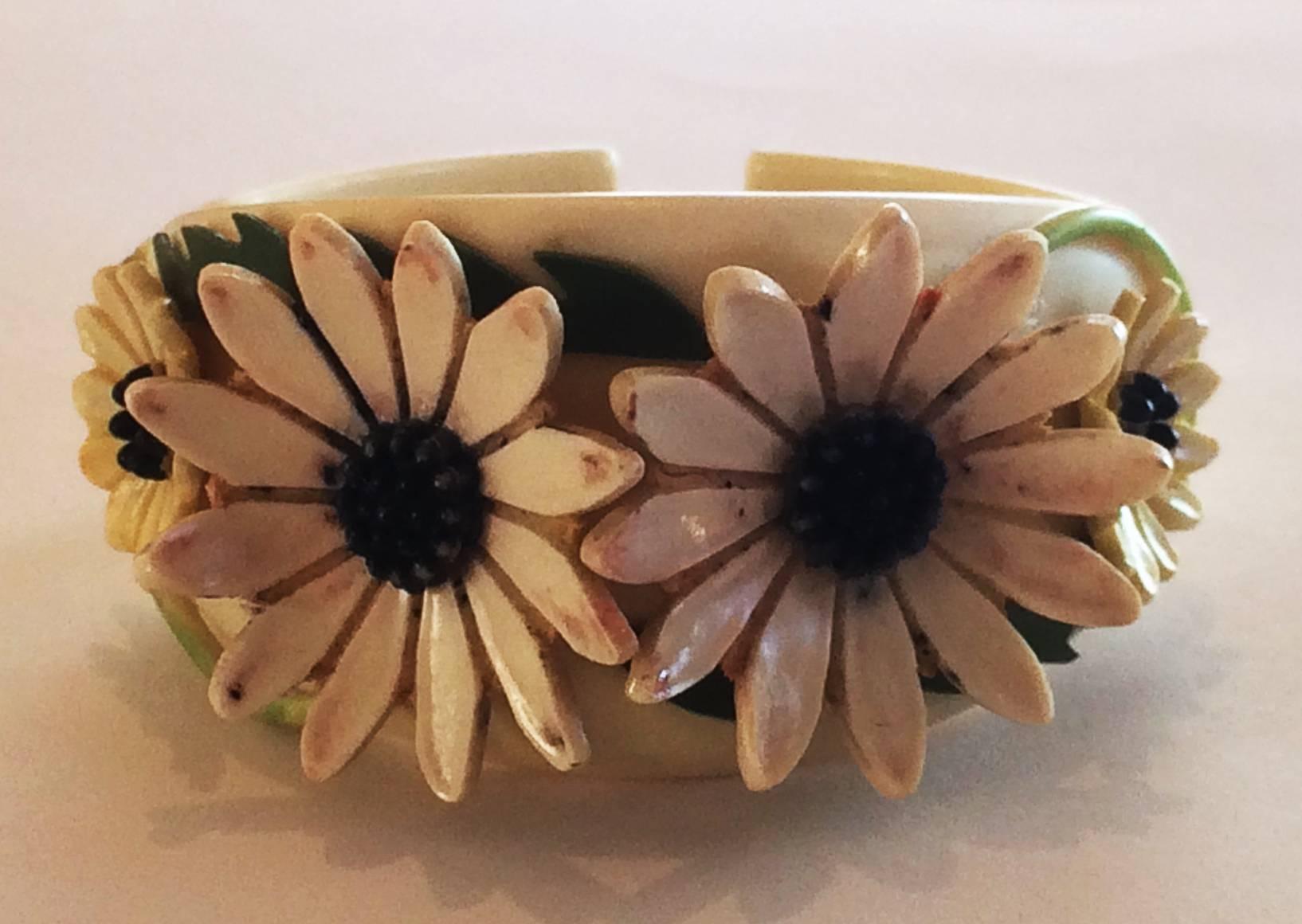Art Deco Bracelet Rare Double Hinge Clamper, in white, with White Daisies, black/blue centres, and with green leaves and stems.  A rare and intricate carved design, all in excellent condition, including the double hinge arrangement, which is very