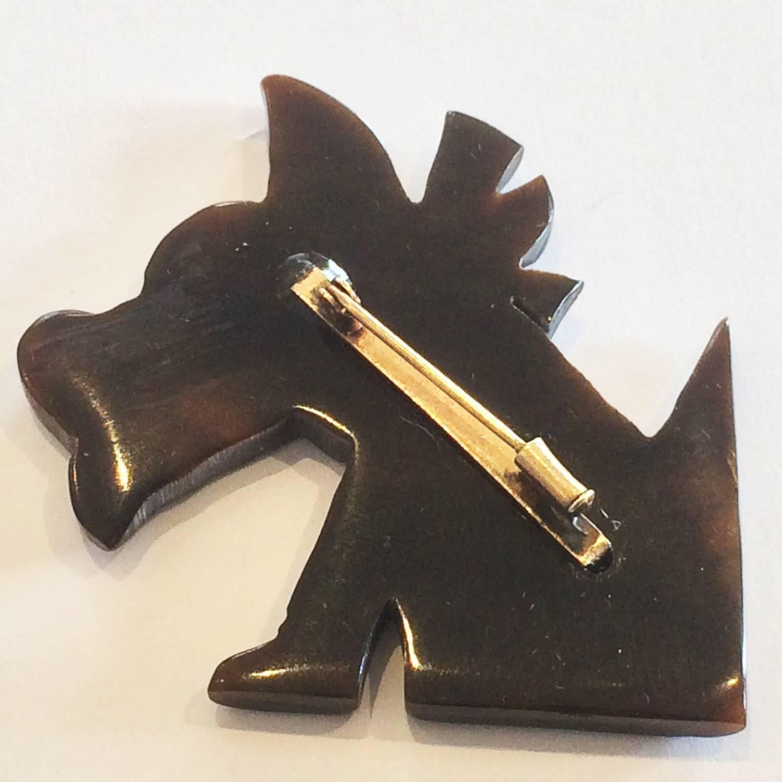 Art Deco Brooch of a cute Scottie Terrier In French Bakelite, with Black Collar and Bow. Highlighted with Painted eye and tongue. The very Old type, Rose gold colour safety Clasp intact and working perfectly. With this sort of clasp, the end cap is