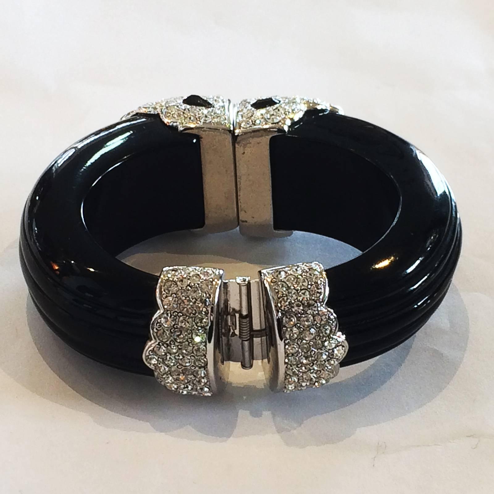 Art Deco Kenneth J. Lane, Clamper Bangle, in Black Enamel body, with Crystal Diamantes at front and rear, and the front highlighted various shaped Black Diamantes, all set in silver tone base. The Bangle has the manufacture mark of “KENNETH” “C”