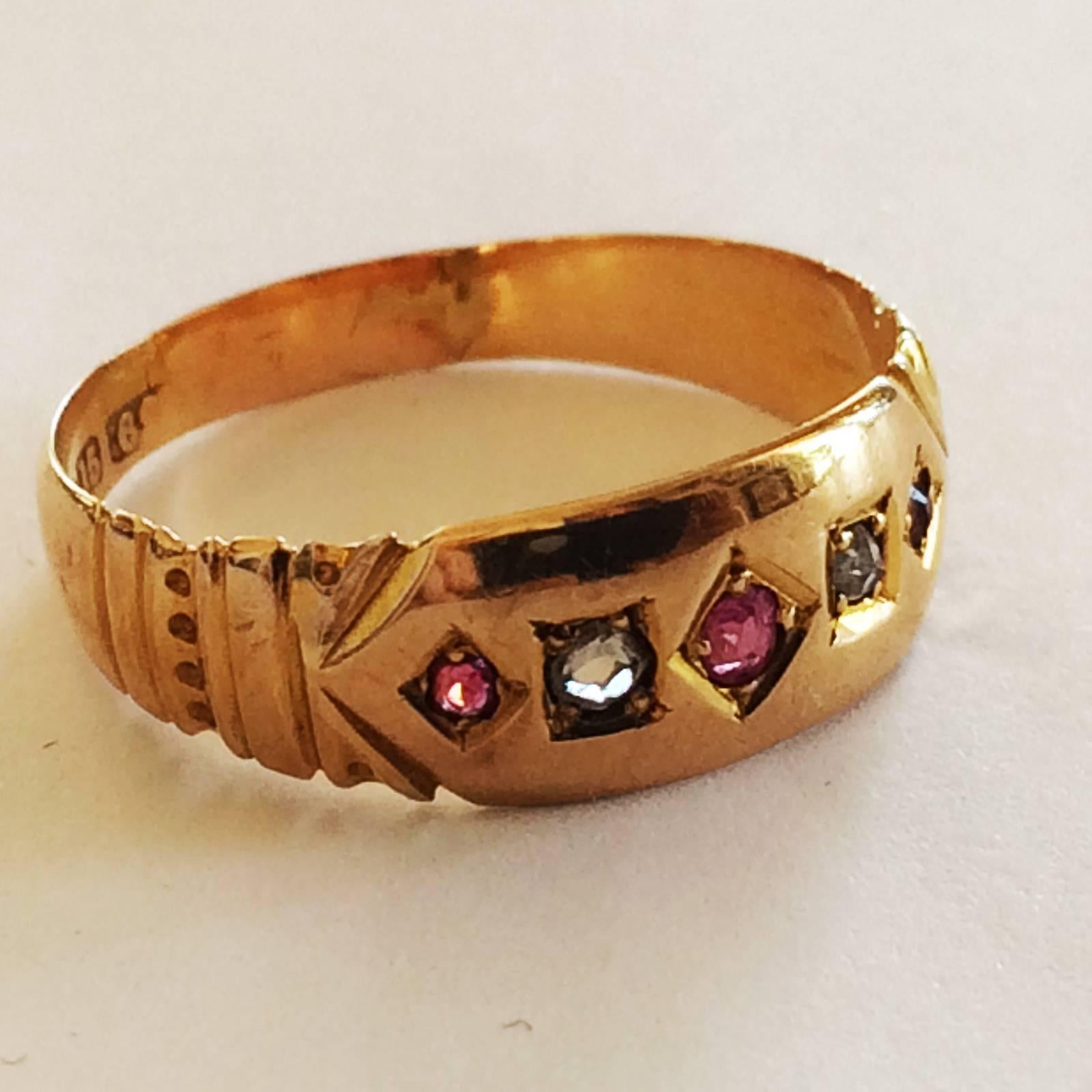 Art Deco Ring in 15ct Gold with Mine Cut Diamonds and Rubies, Hallmarked to the rear with 15 and also 625, partly rubbed, representing 15ct gold, with also Hallmark with 3 marks within an impressed shield. Very finely carved to the shoulders and