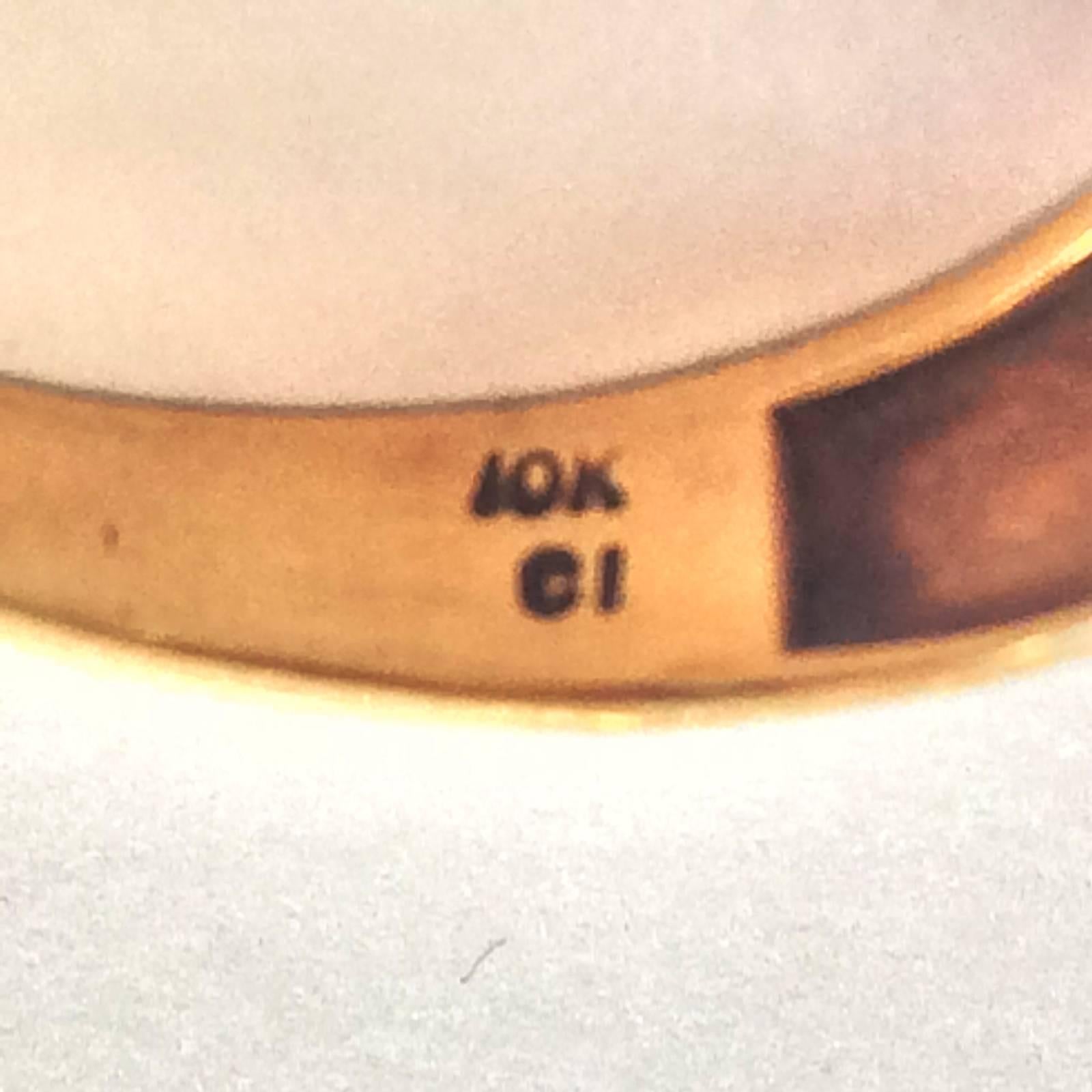 Art Deco Signet Ring in 10k Gold as hallmarked to rear, set with a Natural Emerald, oval cut, with reeded finish to gold shoulders, top with 2 small diamonds to each shoulder as well. Also Hallmarked CI beside the Gold Mark, probably Jeweller’s